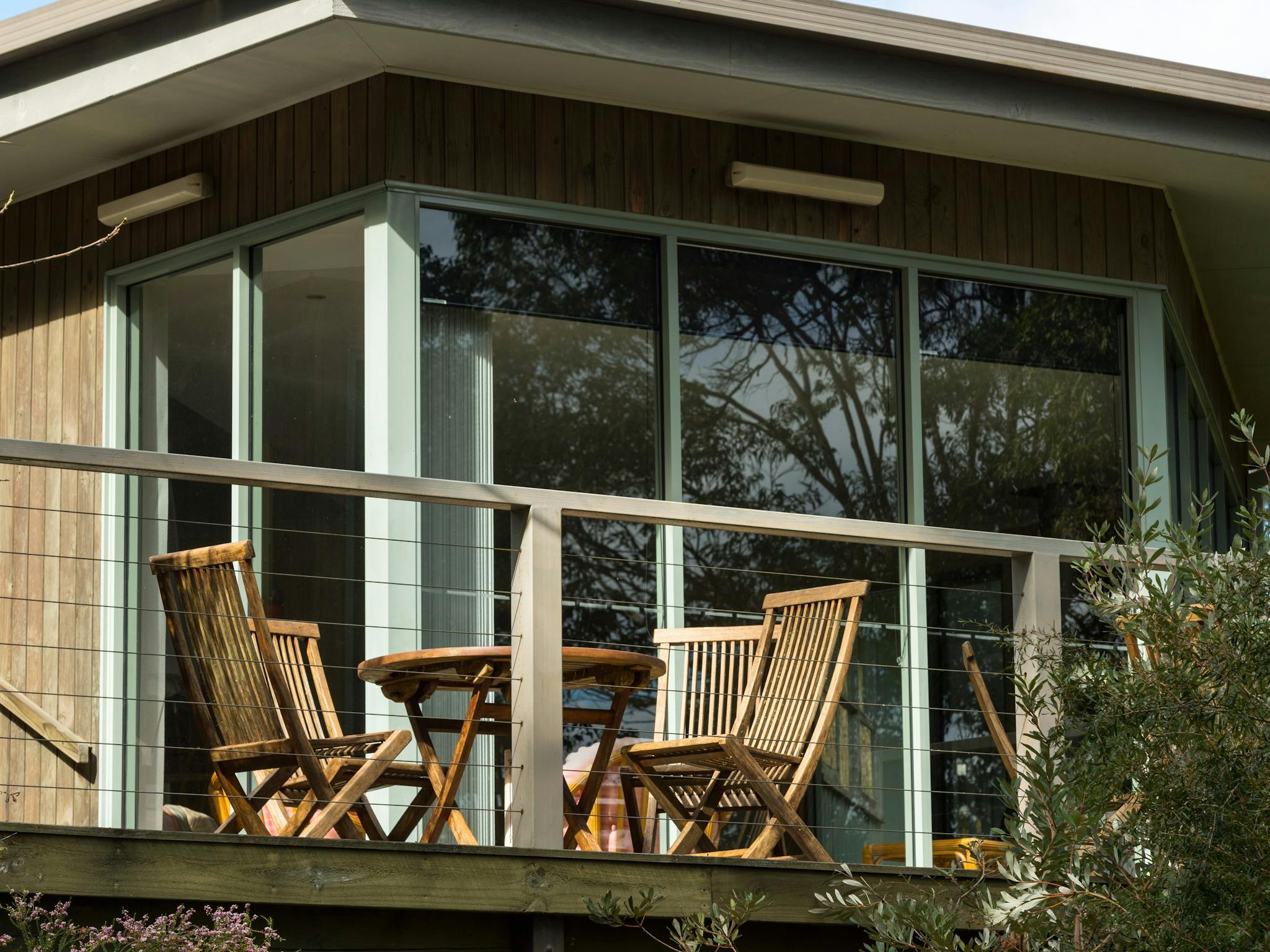 Outdoor dining area on front balcony of Lodge