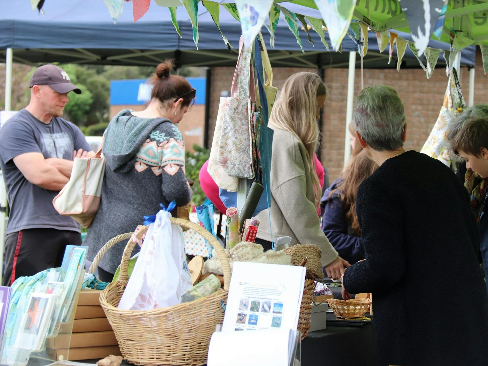 Small group of perople shopping at the markets on the Normanville Village Green