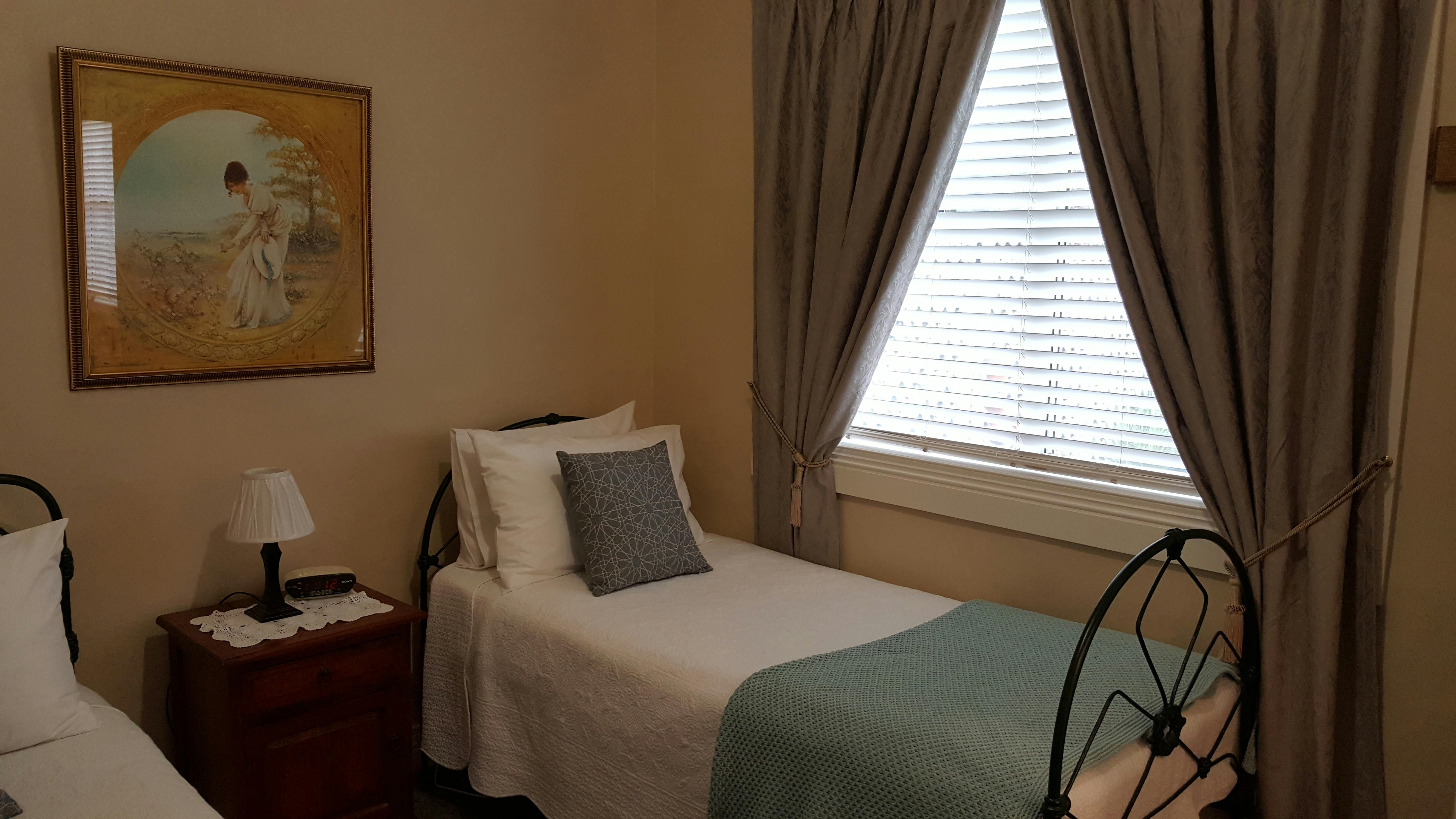 Bedroom 2 - has 2 single beds with electric blankets. View through window to private courtyard.