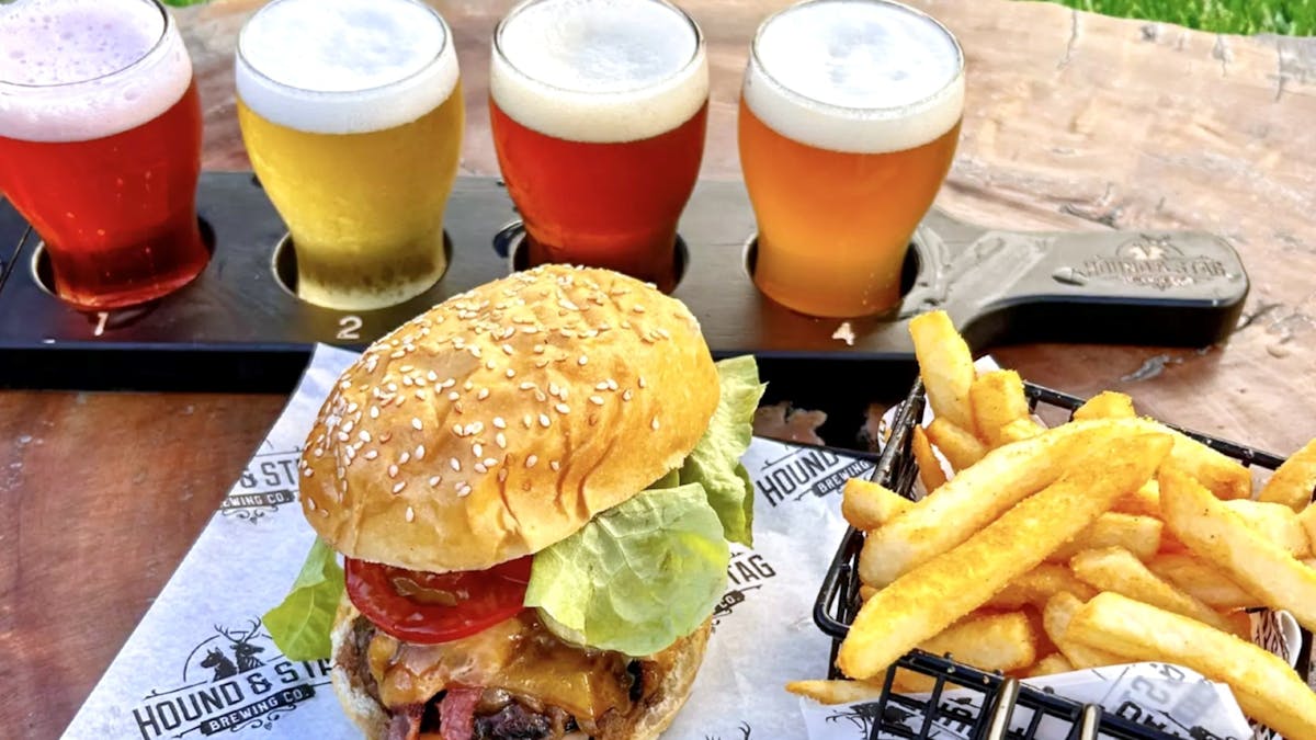 Hound Beef Burger with fries and beer paddle