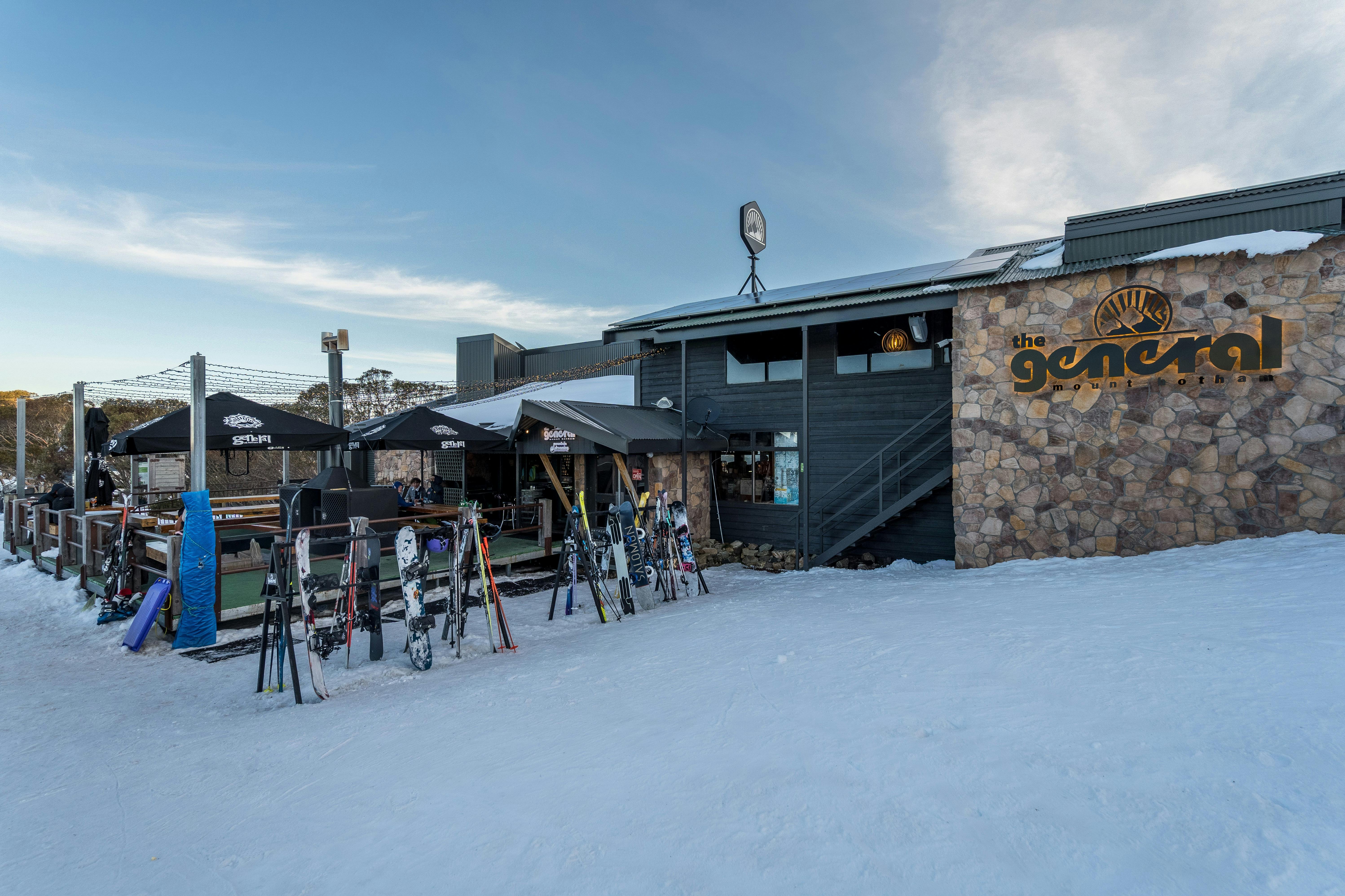 Front view of the building. Outside fireplace on front deck, ski and snow board racks