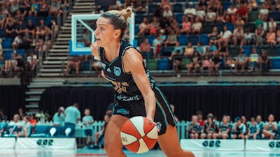 Basketball player dribbles the ball while running.
