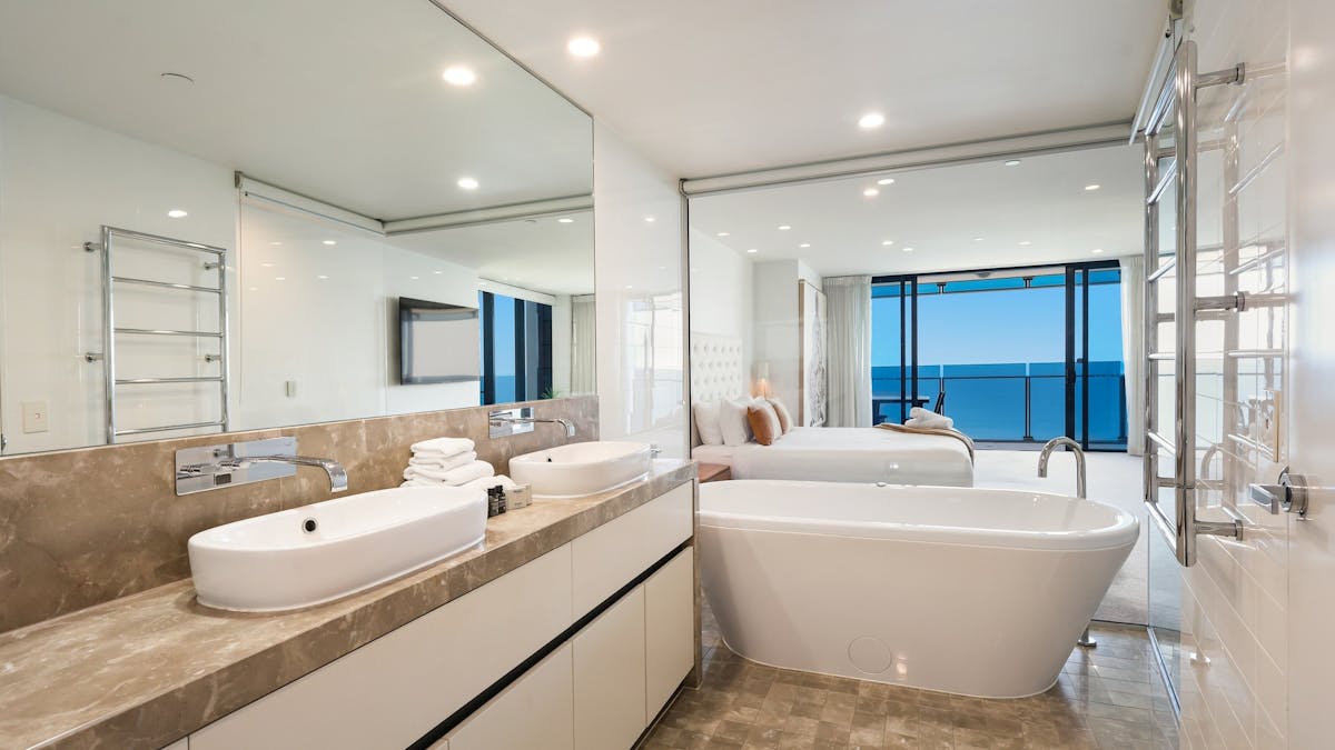 Main ensuite with bath tub,  and ocean views, his and her vanity