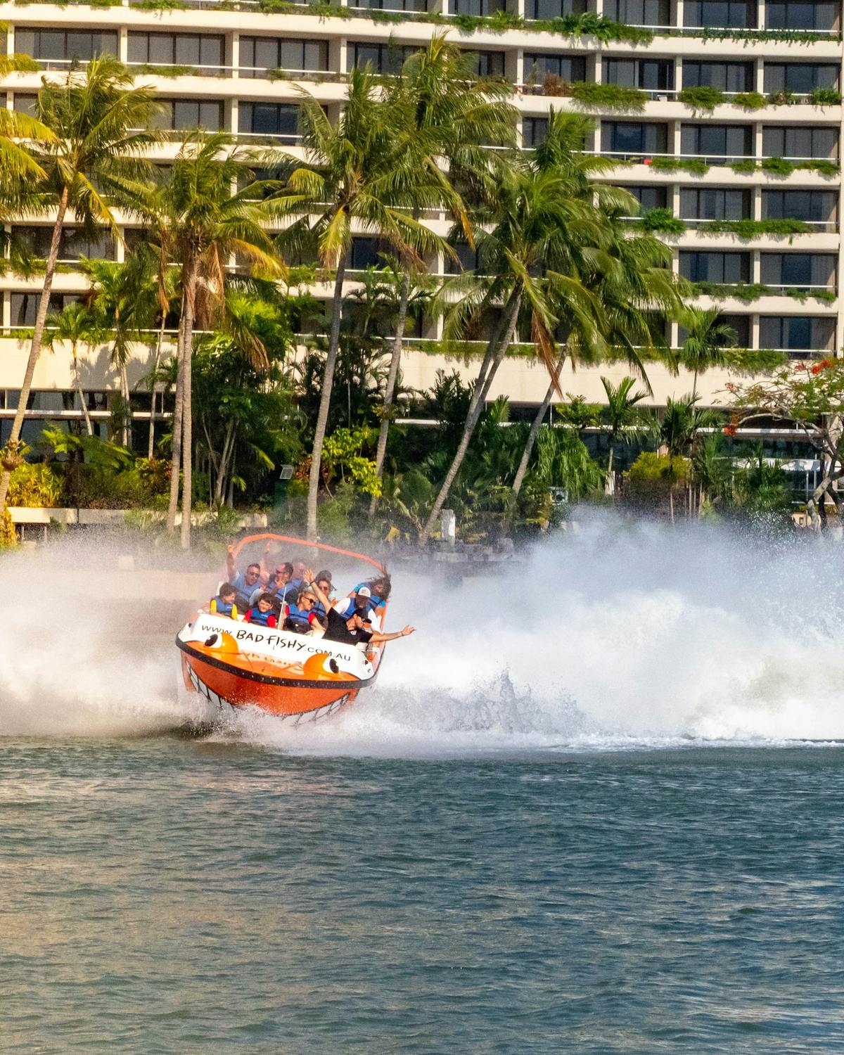 Cairns Jet Boating's Bad Fishy boat creating huge waves as it cuts through the Trinity Inlet