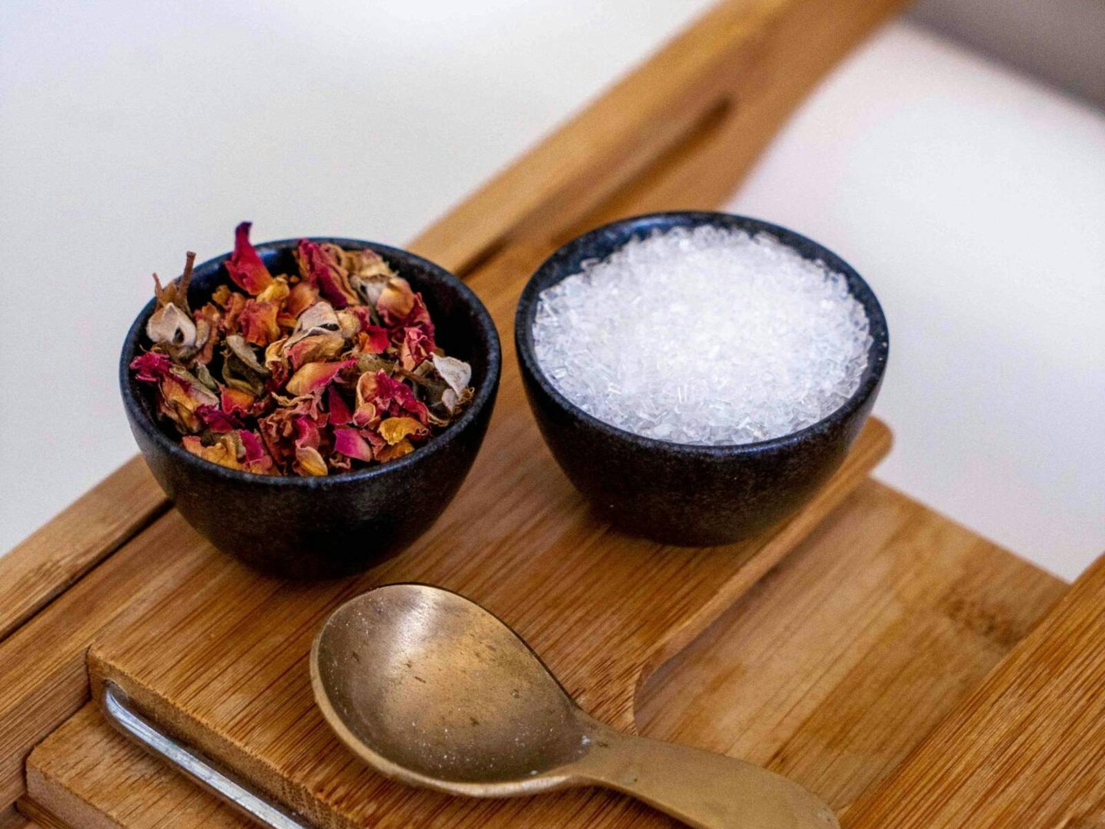 bath salts and petals on timber board