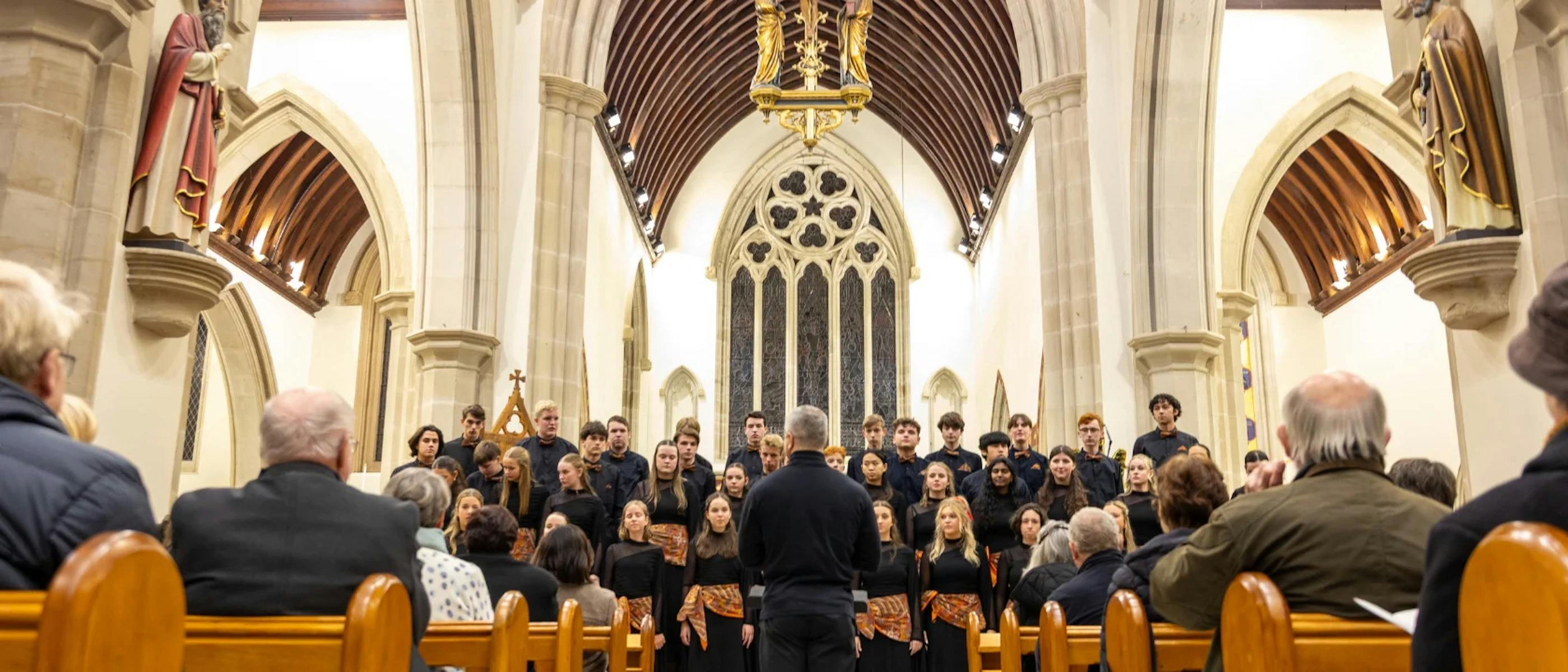 A choir sings in a cathedral