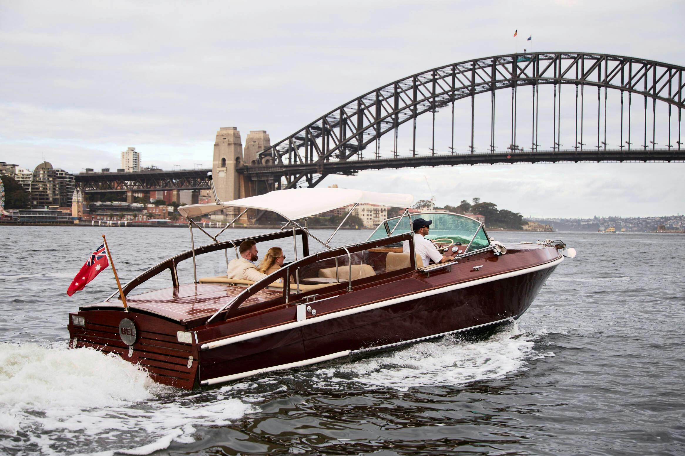 MV BEL luxury cruise boat on Sydney Harbour with Harbour Bridge in the background.