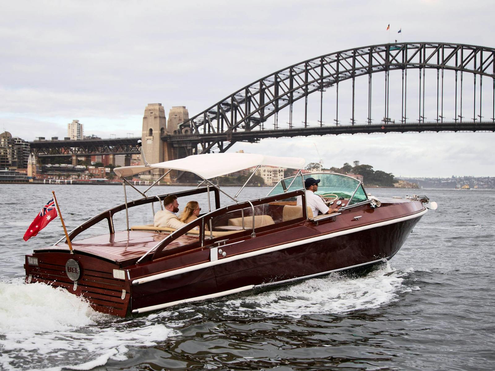 MV BEL luxury cruise boat on Sydney Harbour with Harbour Bridge in the background.