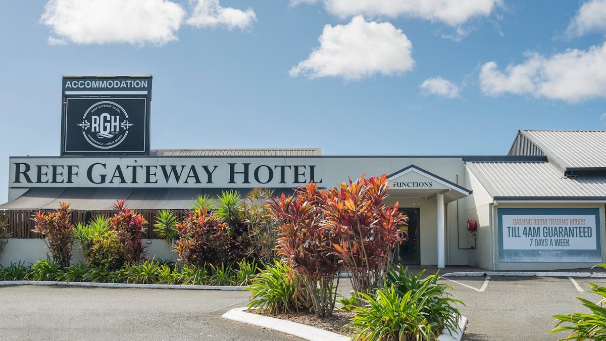 Front entrance to Reef Gateway Hotel with a large parking space