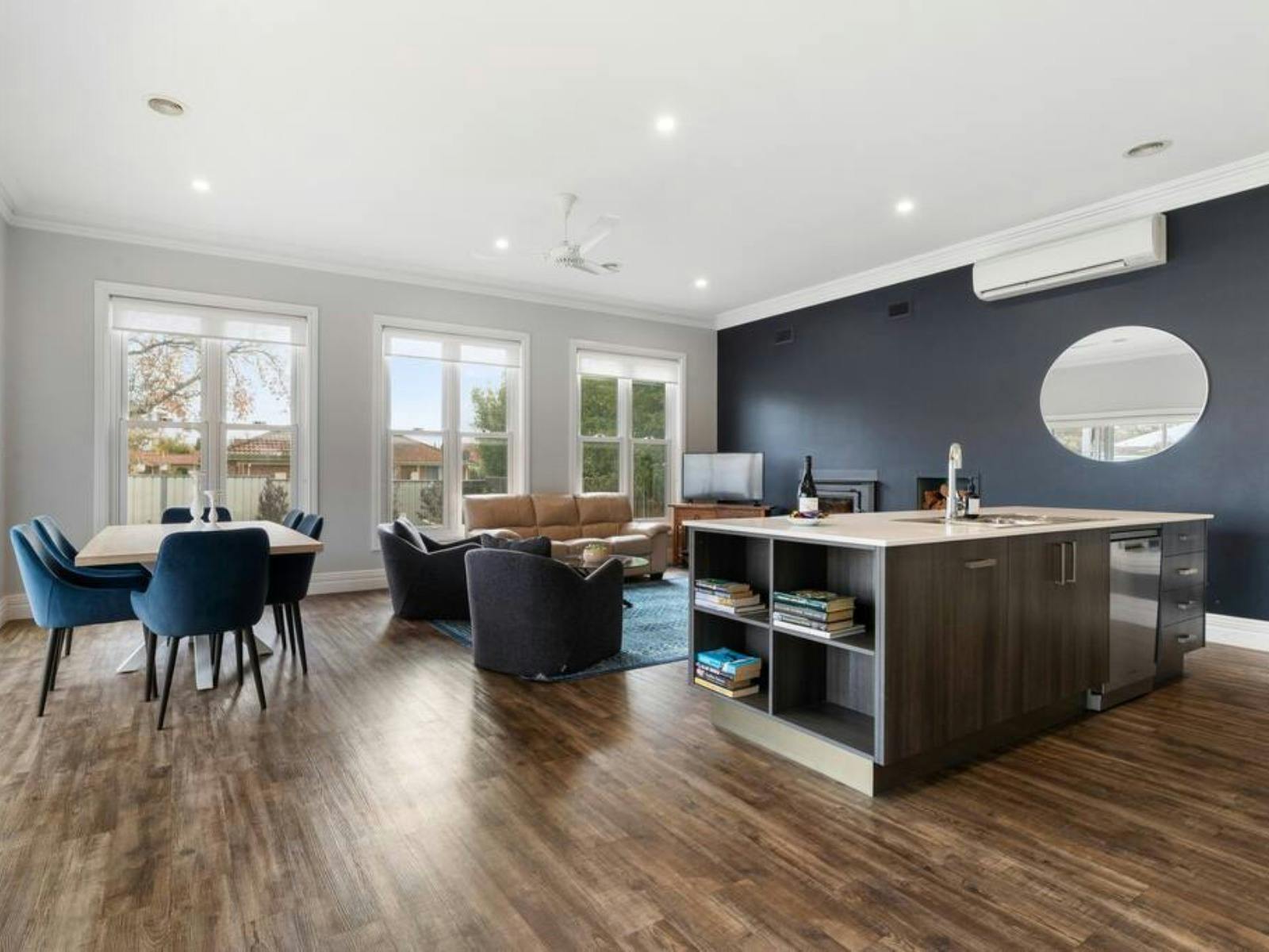 Large open living area with kitchen, dining and lounge with fireplace.