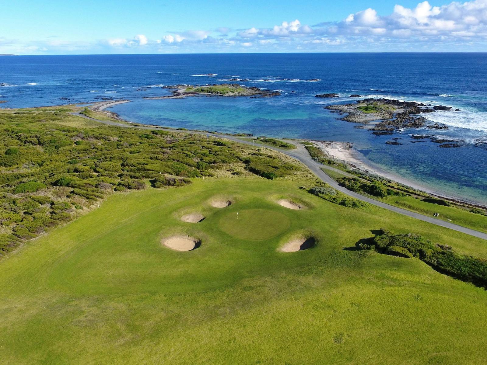 This is a photo of the third green on the King Island Course.  The green is by the sea.