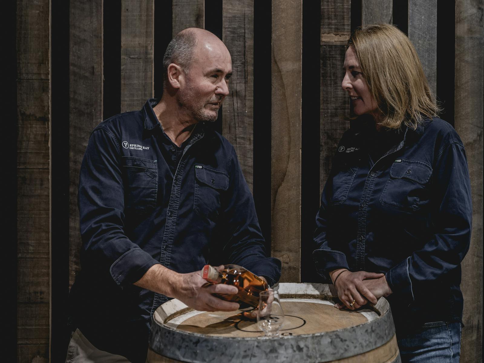 Cam and Suzy Brett with a barrel and whisky