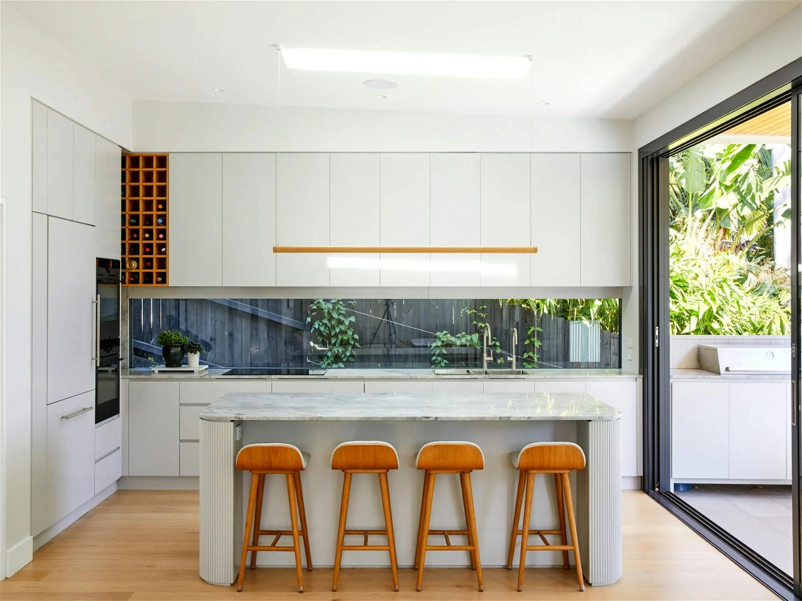 the stunning kitchen, complete with top-of-the-line appliances, marble benchtops and breakfast bar