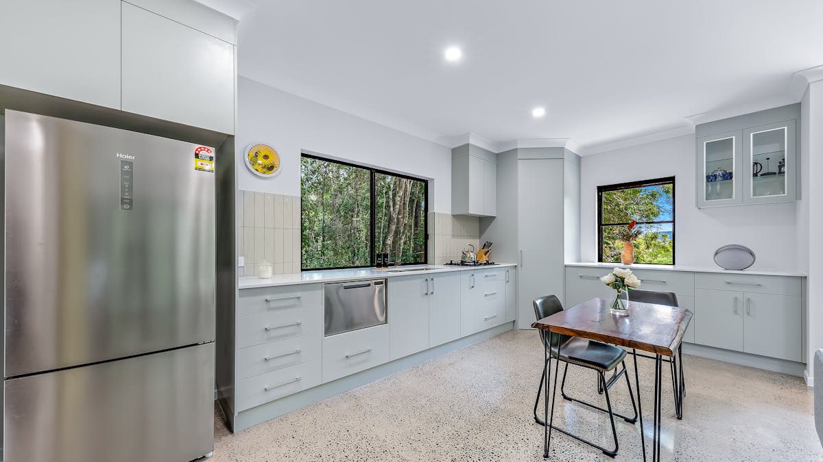 Kitchen showing fridge, dishwasher, stove and bluetooth speaker