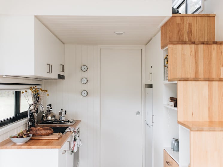 Galley kitchen with a door leading through to the bathroom