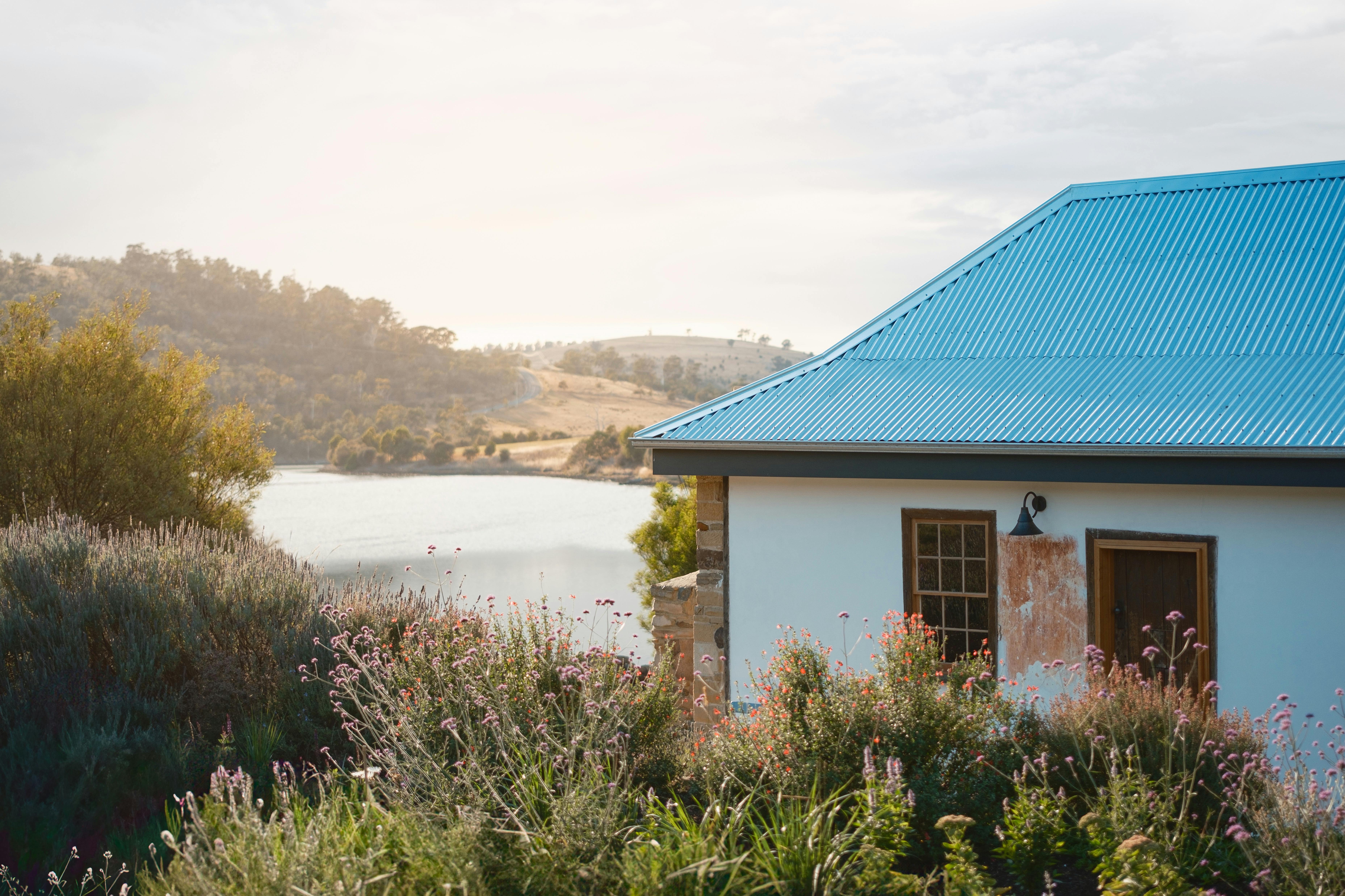 cottage on the left, gardens to the front, river to the back