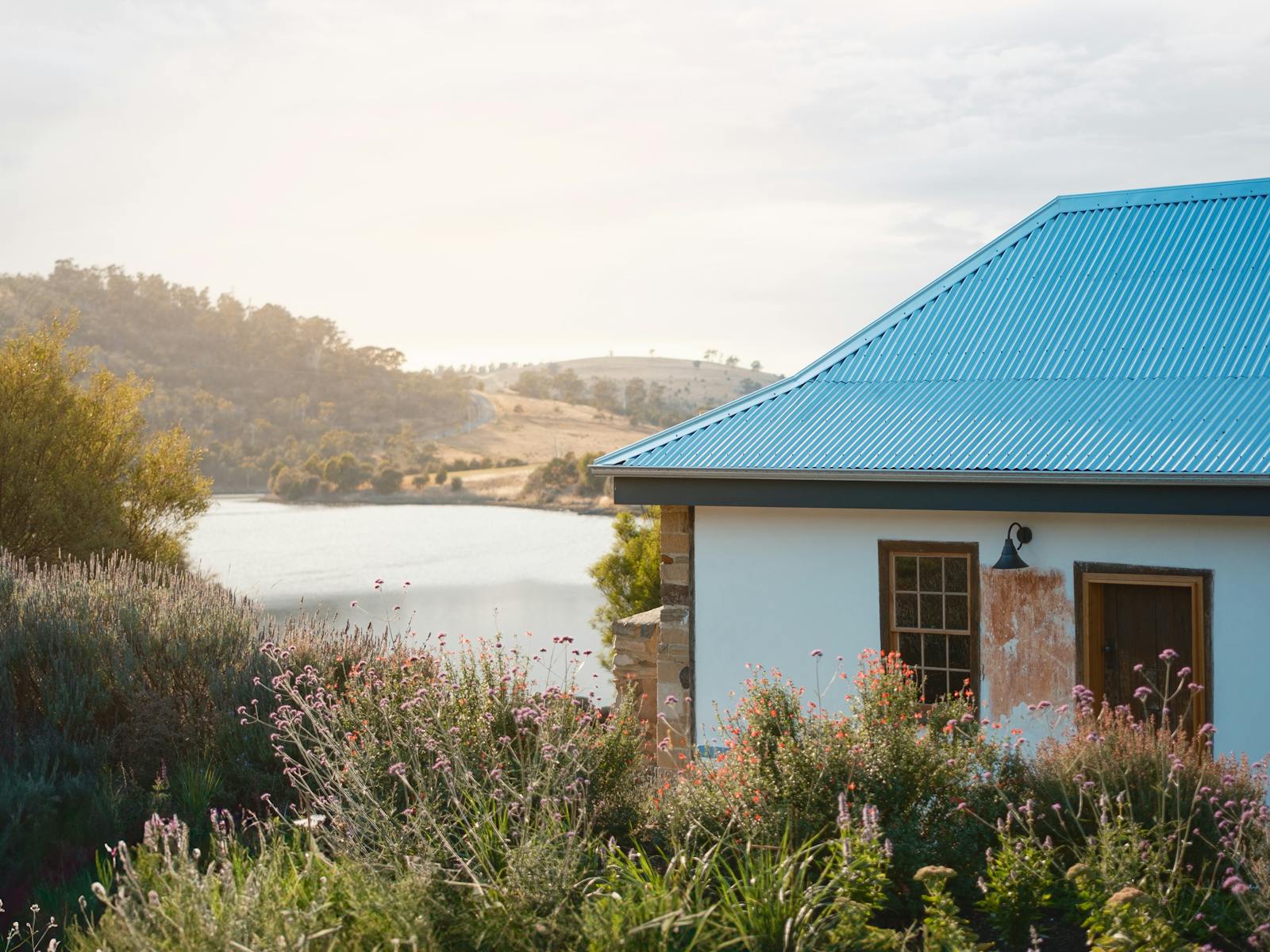 cottage on the left, gardens to the front, river to the back