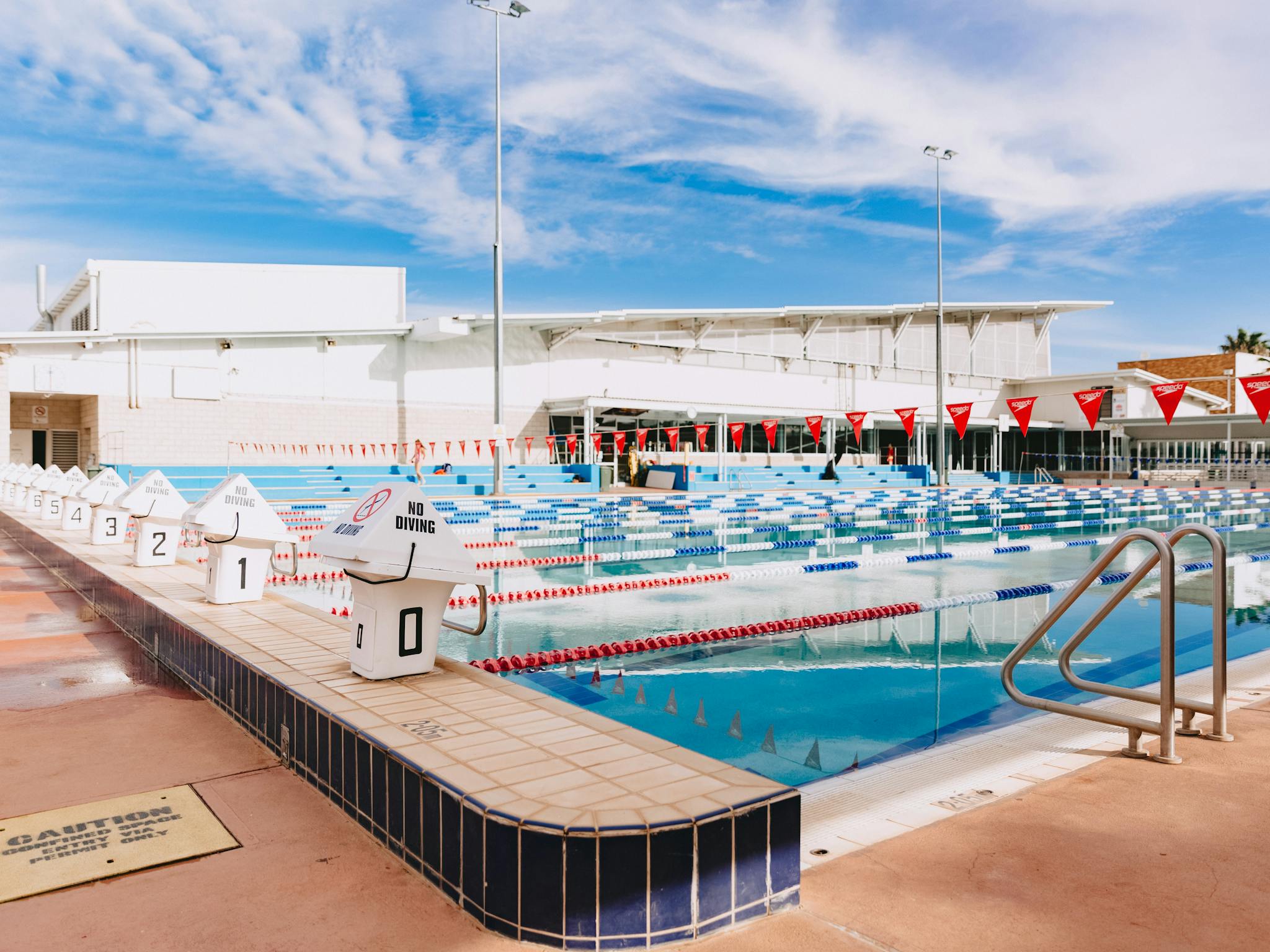 view of the outdoor swimming pool with diving platforms in sight
