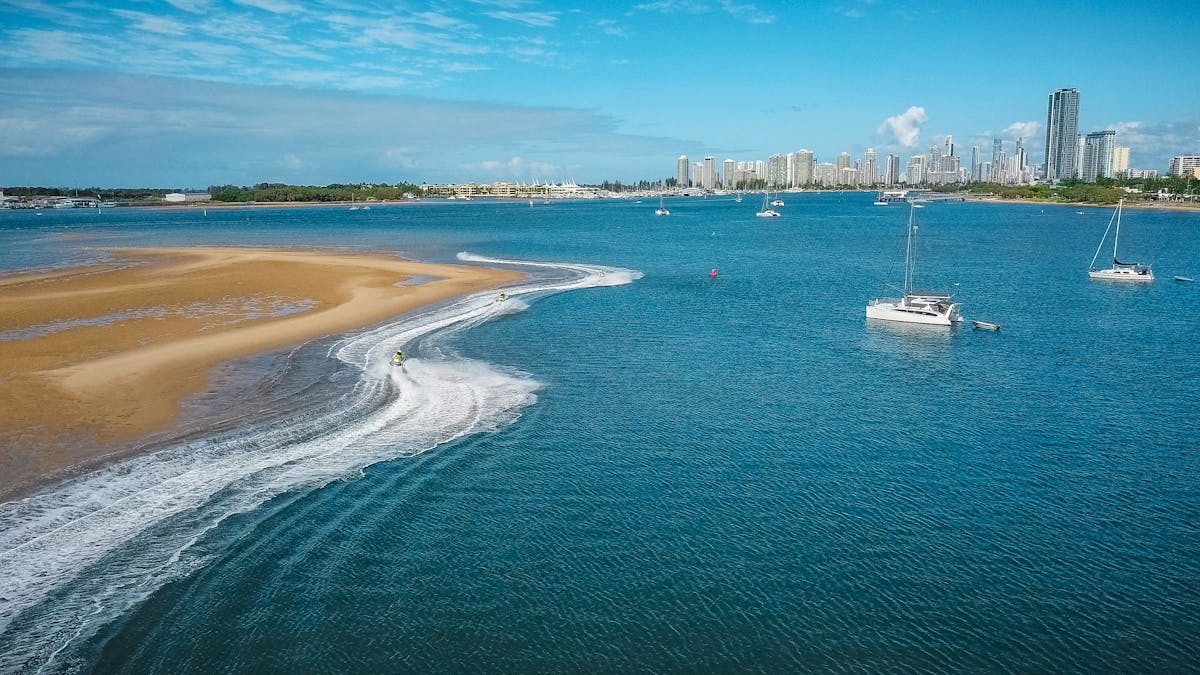 Skis riding around a sandbar on the Gold Coast