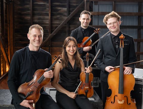 Members of the Alma Moodie Quartet holding their instruments