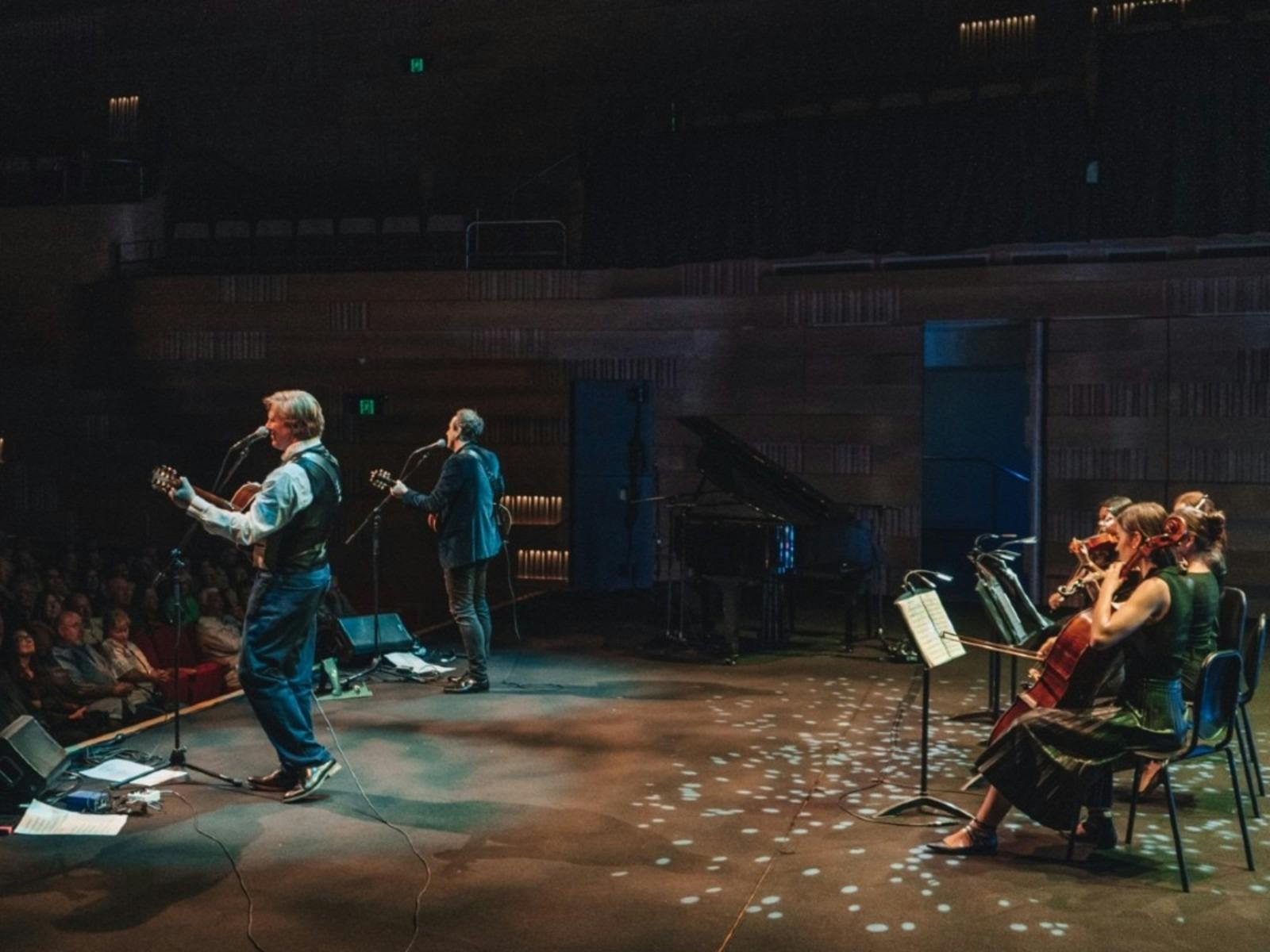 Damien, Darren and a Stringed Quartet onstage performing to audience