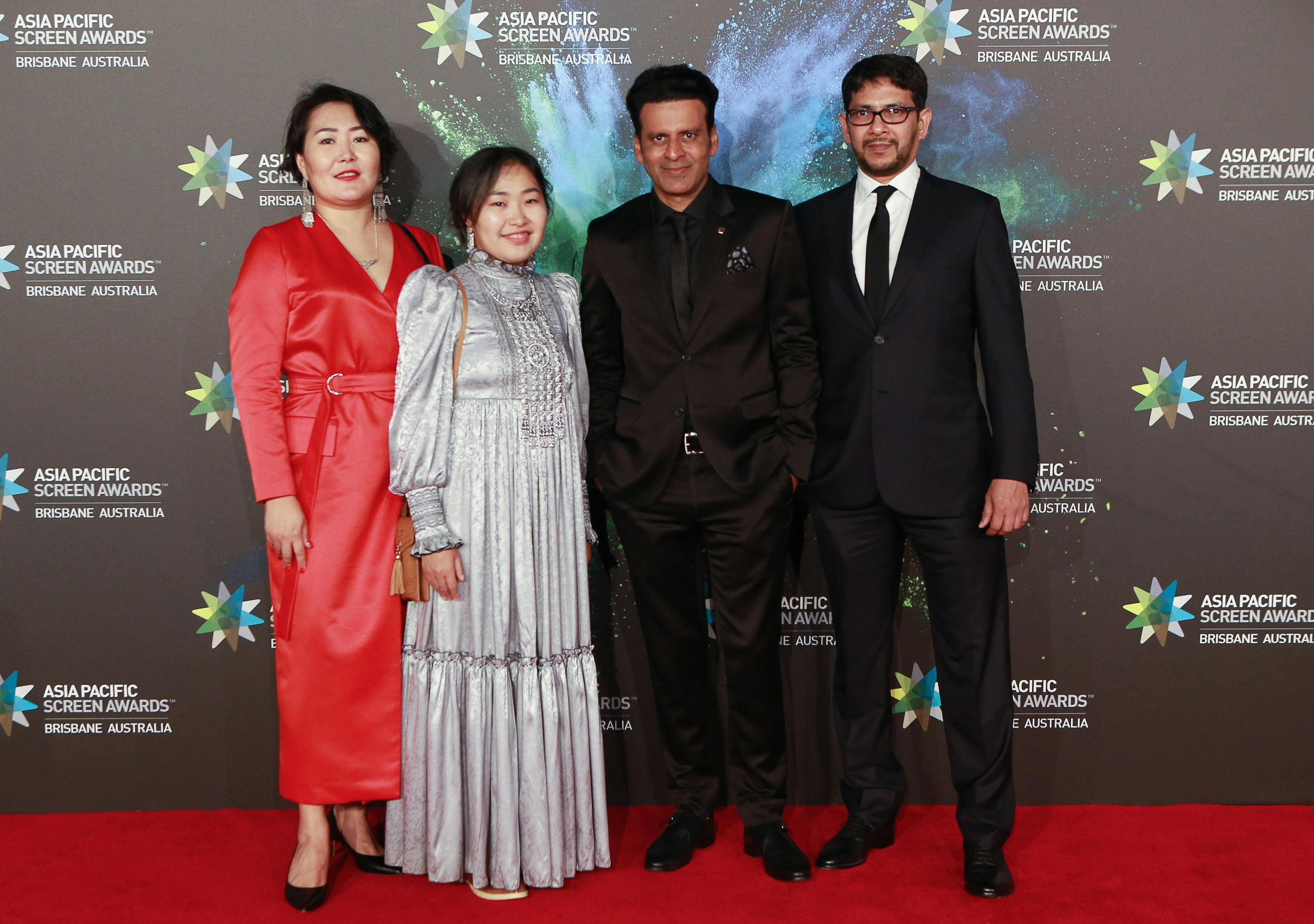 Four people on the red carpet