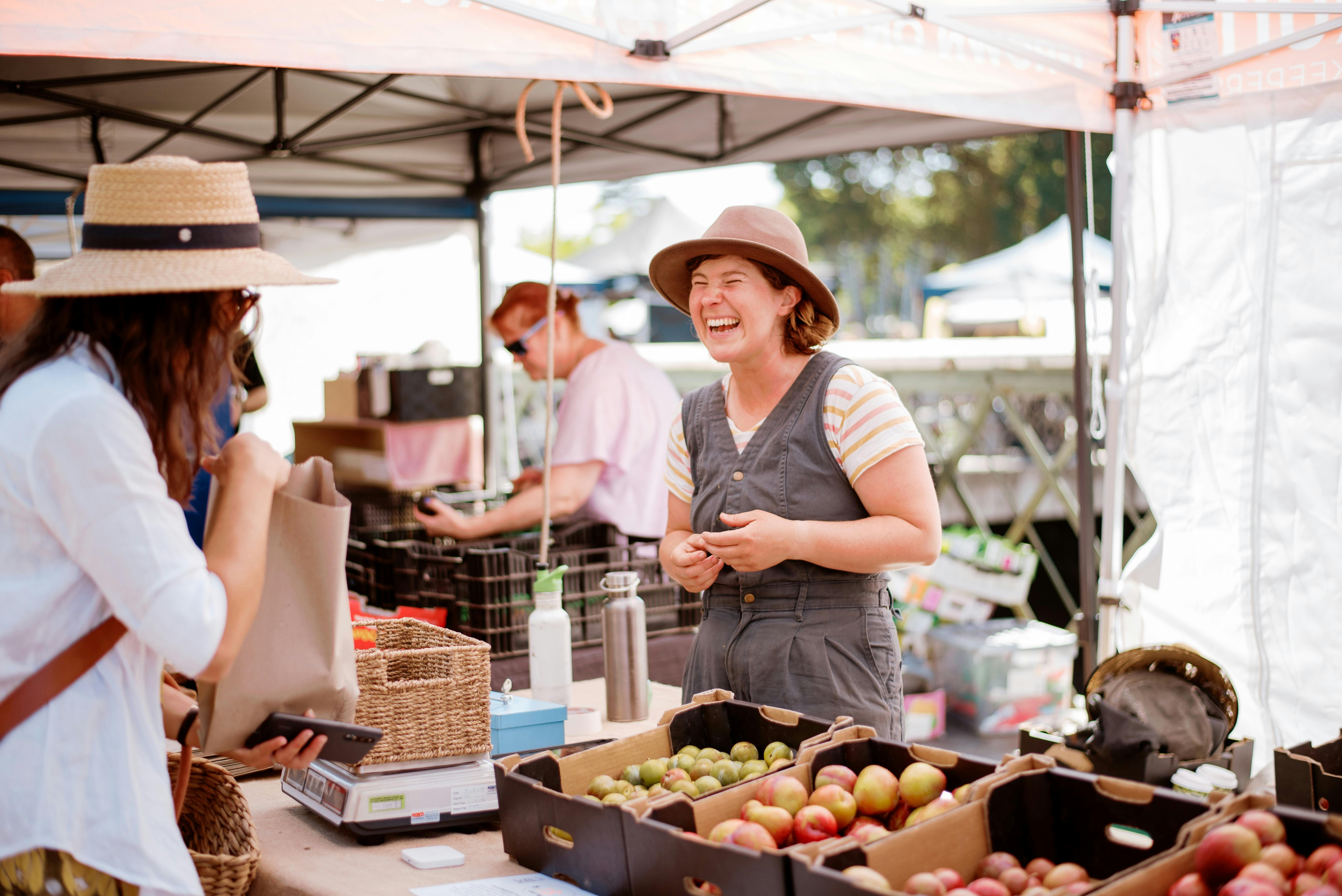 A lady selling apple varieties at the Bendigo Farmers Market