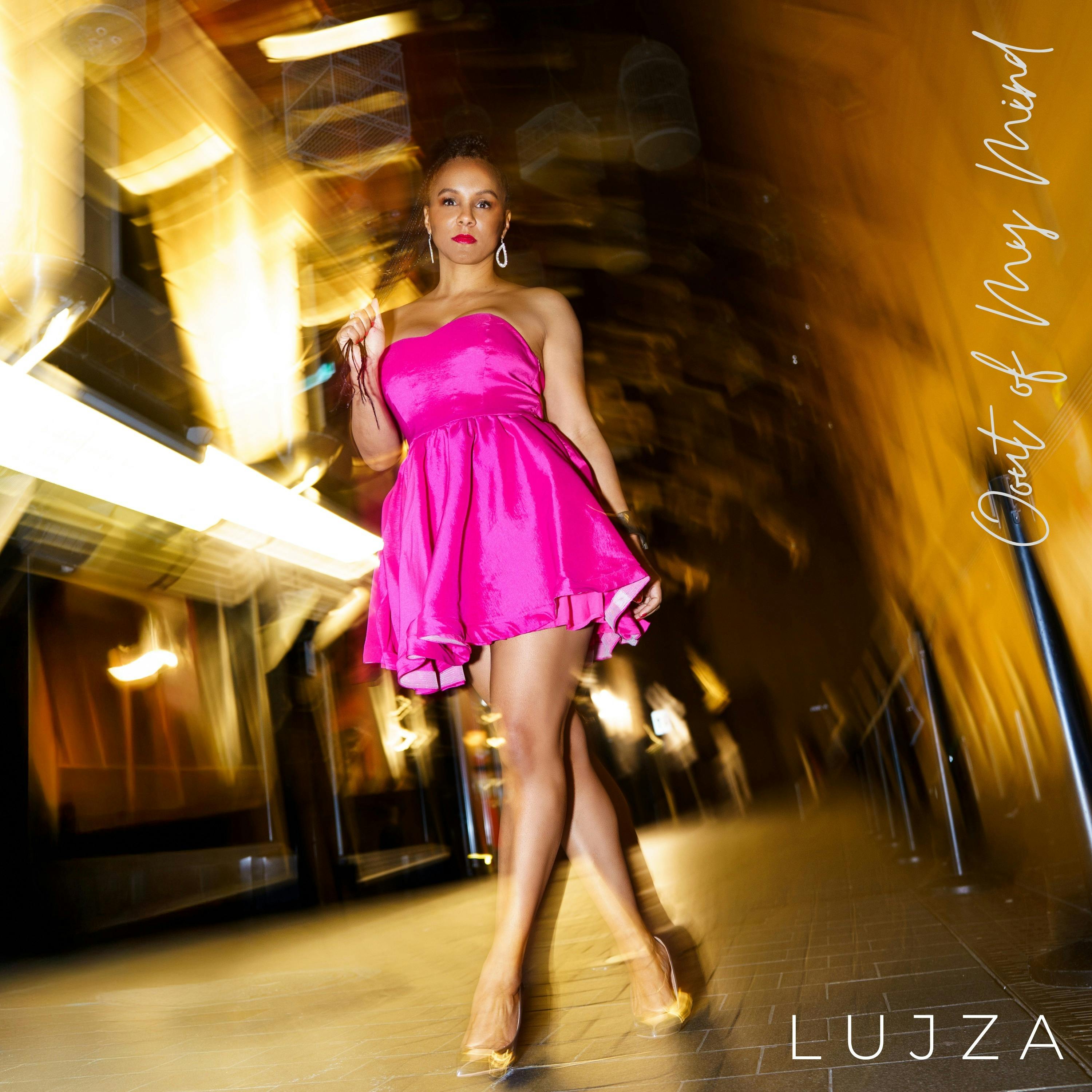 Lujza walking through an alley in a pink dress and silver shoes