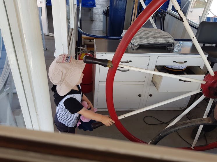 Young passenger at the helm of the Paddle Steamer Melbourne