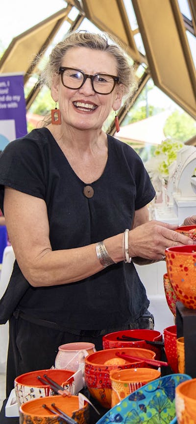 Photo of a market vendor with her ceramics inside the Museums Gandel Atrium