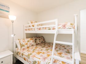 The second bedroom contains a duo bunk consisting of a double bed below and a single bed on the top.