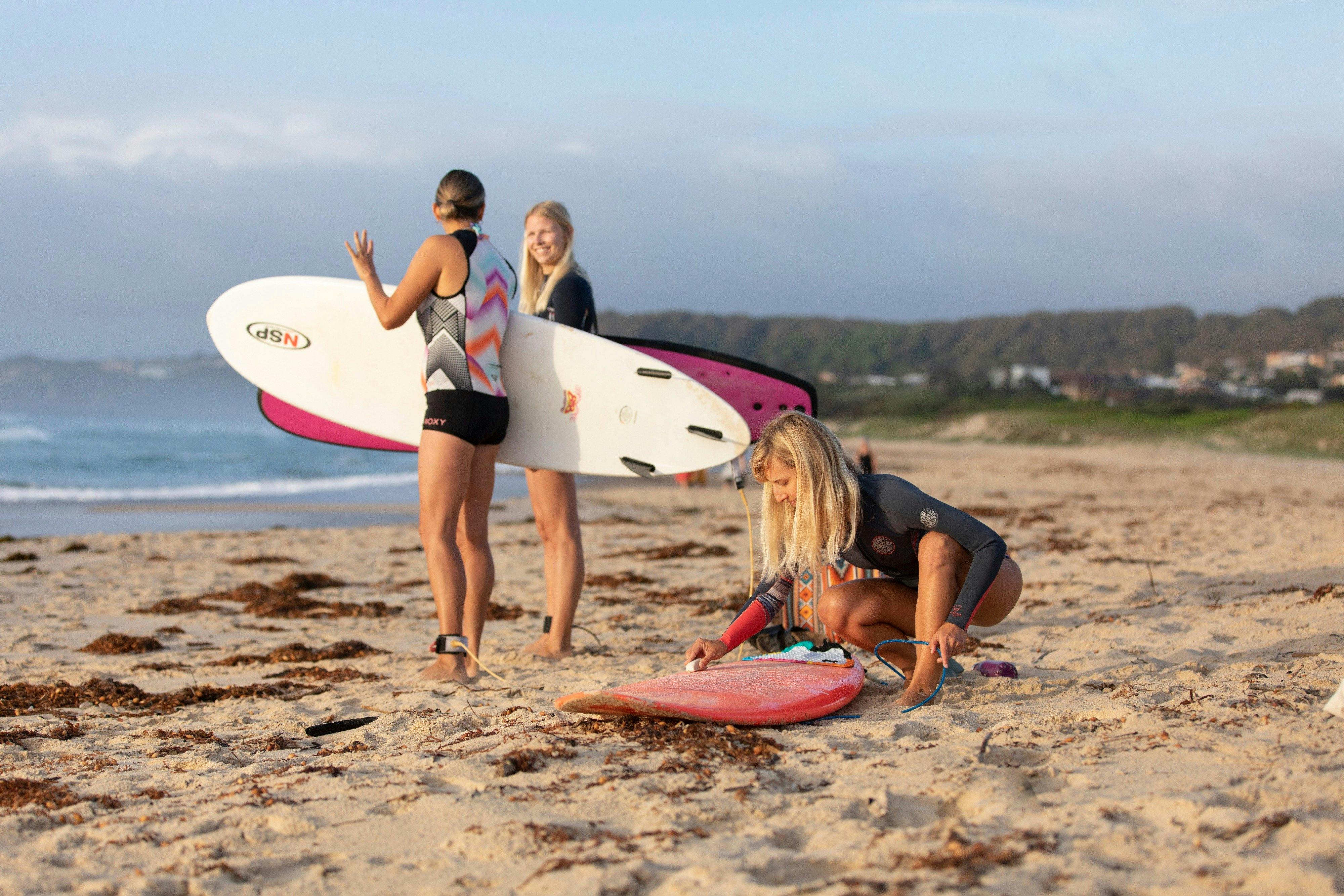 Women surfing beach