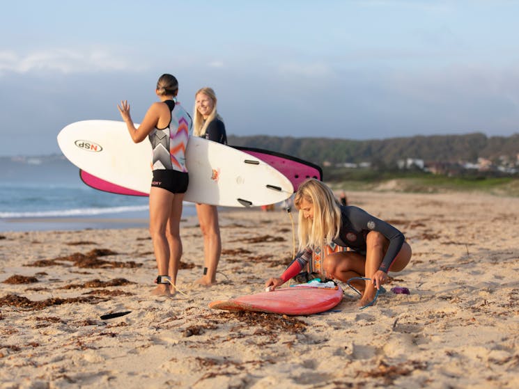 Women surfing beach