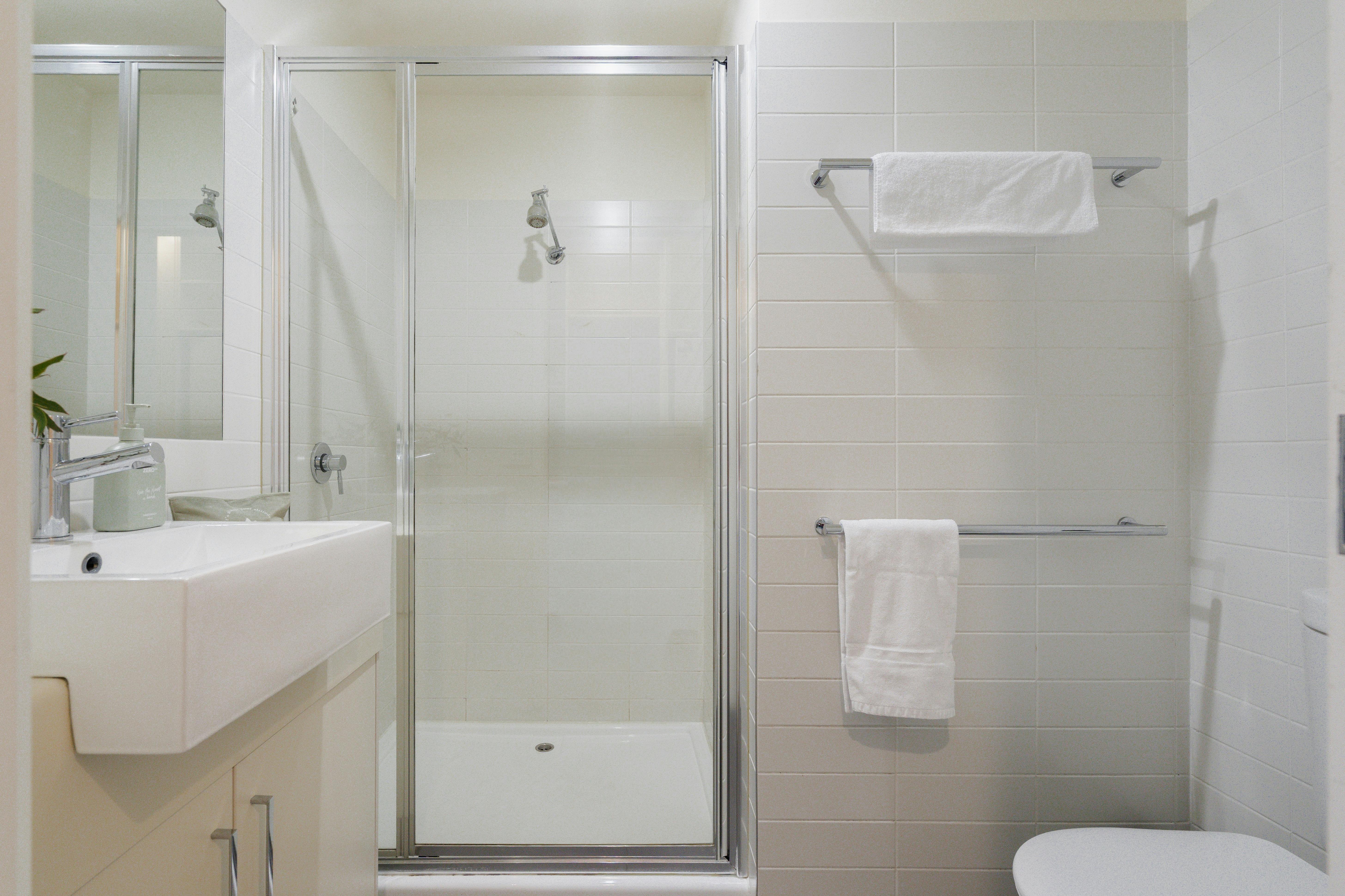 Main bathroom on top floor of 2 bedroom apartment. Shower, vanity and toilet.