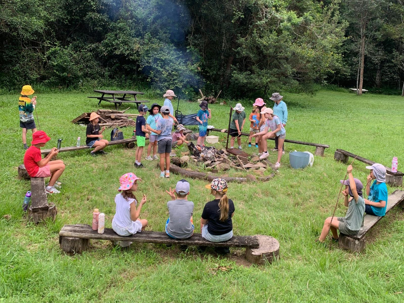 Children cooking on campfire at Birdwings Forest School Kids Holiday Nature Adventures Gold Coast Hi
