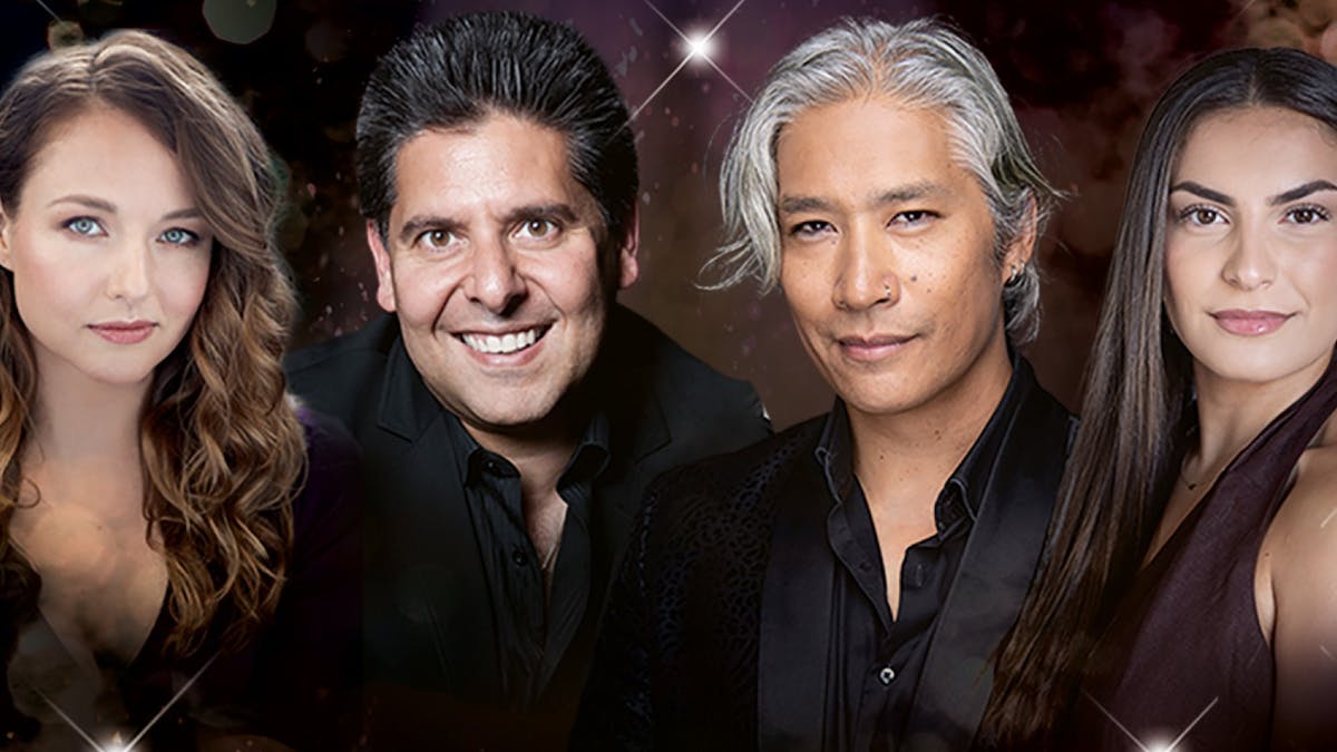2 men and 2 ladies in a row,  dressed in black and smiling at the camera