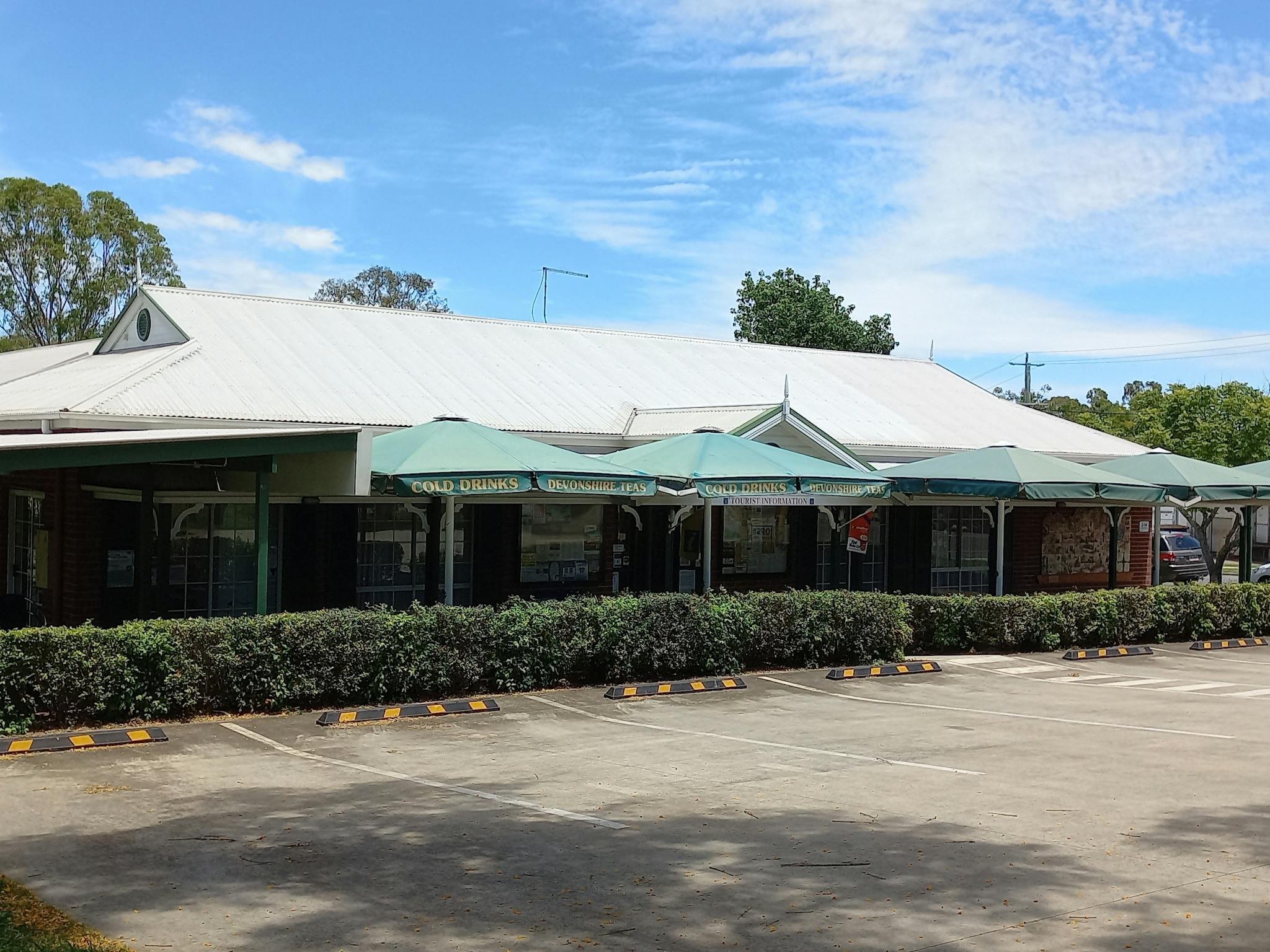 Our lovely building with the umbrellas over our Tea Garden for shade while enjoying a Devonshire Tea Our lovely building with the umbrellas over our Tea Garden for shade while enjoying a Devonshire Tea