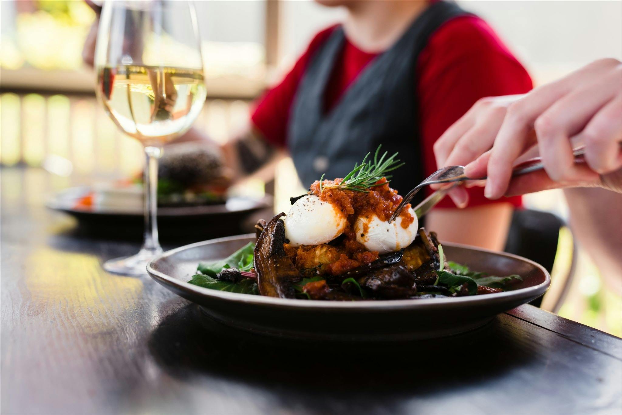 eating lunch with glass of wine at table with friends