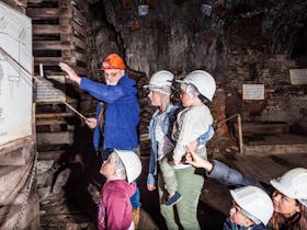 Mine Manager Geoff Anderson underground with a family on a tour deep underground.