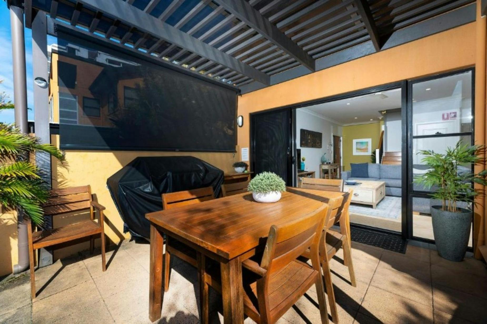 Alfresco area with dining setting and barbecue