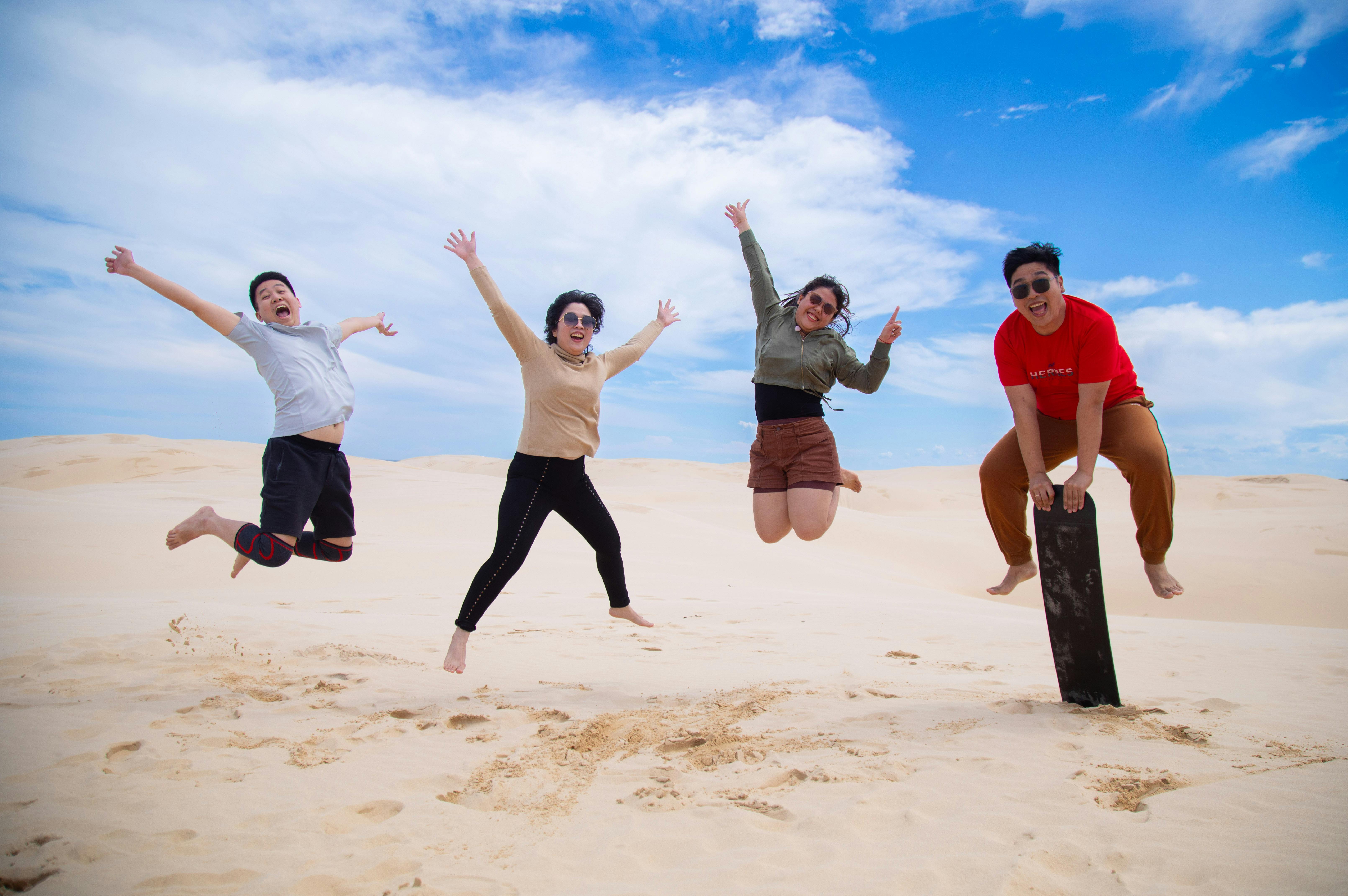 Brighton Tours guests enjoying the thrill of sandboarding while in Port Stephens
