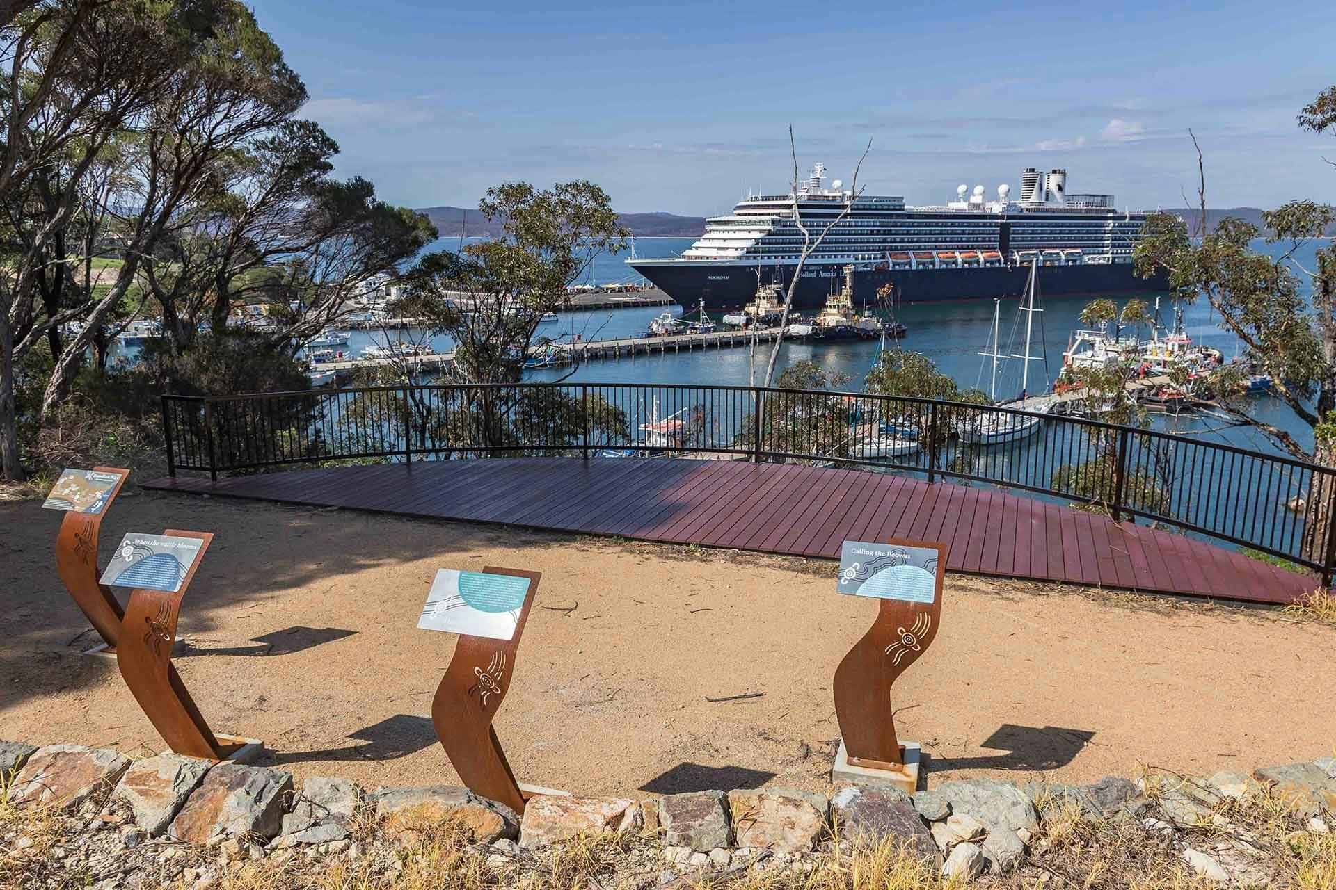 Large viewing deck with beautiful interpretive signage, cruise ship berthed in background