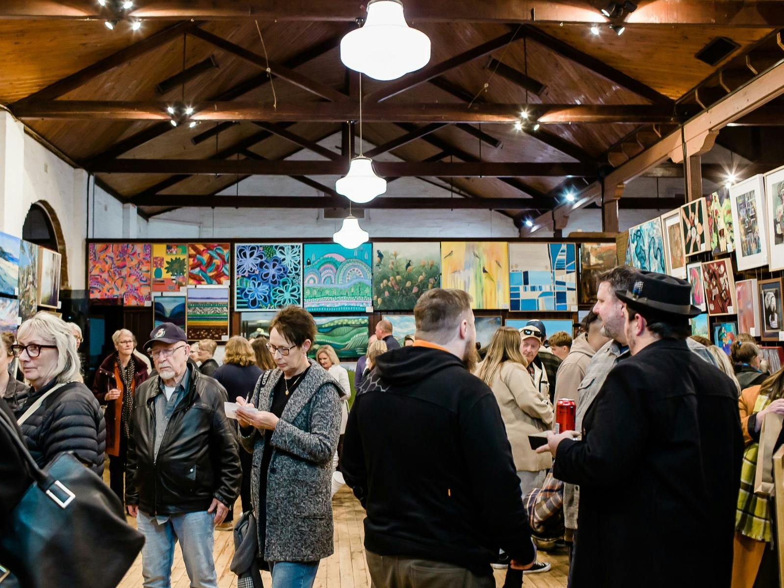 A crowd of people looking at the exhibitions inside