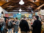 A crowd of people looking at the exhibitions inside