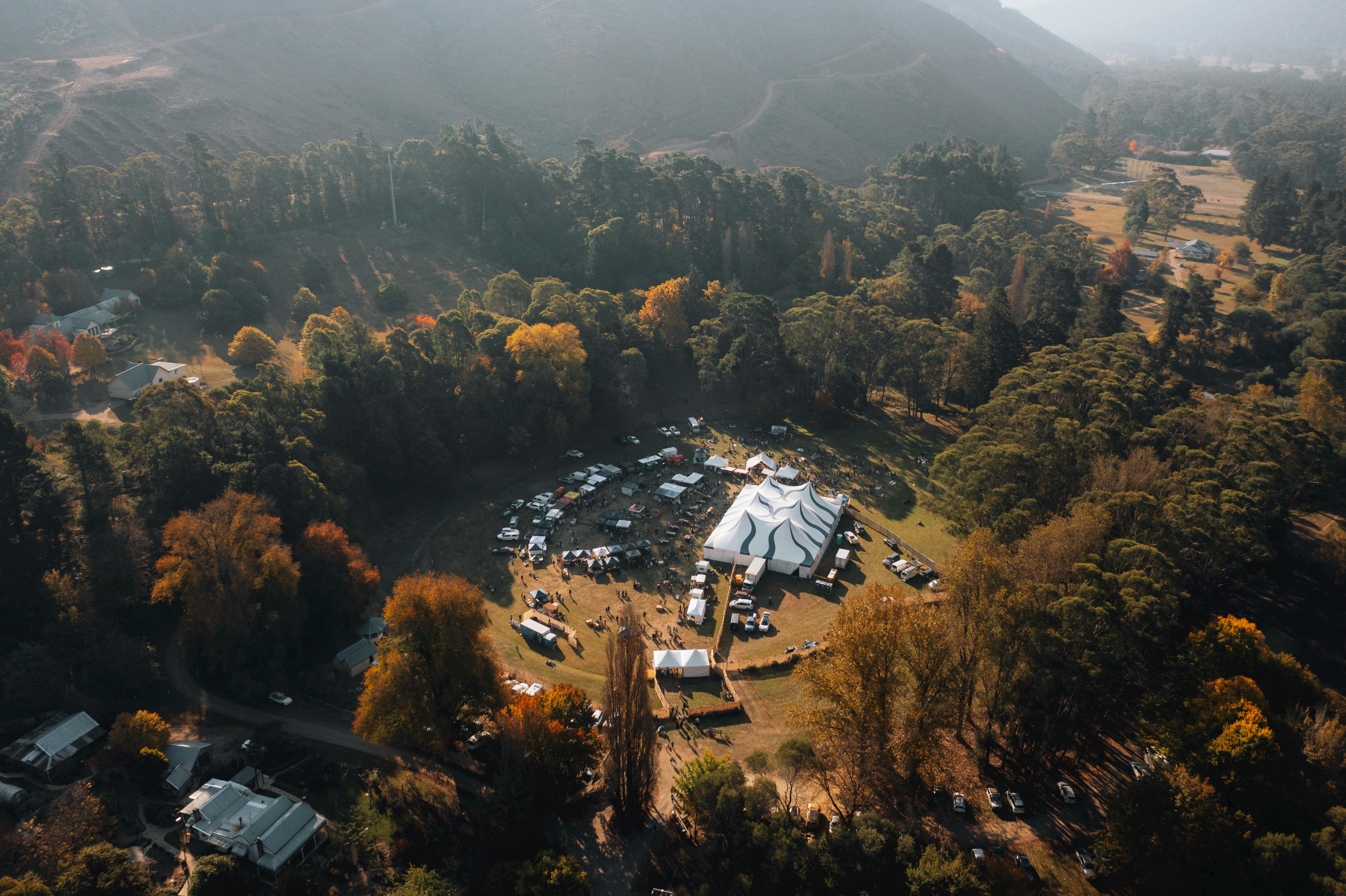 Birds eye view of the 2024 festival with big top tent and stalls surrounded by autumn colours