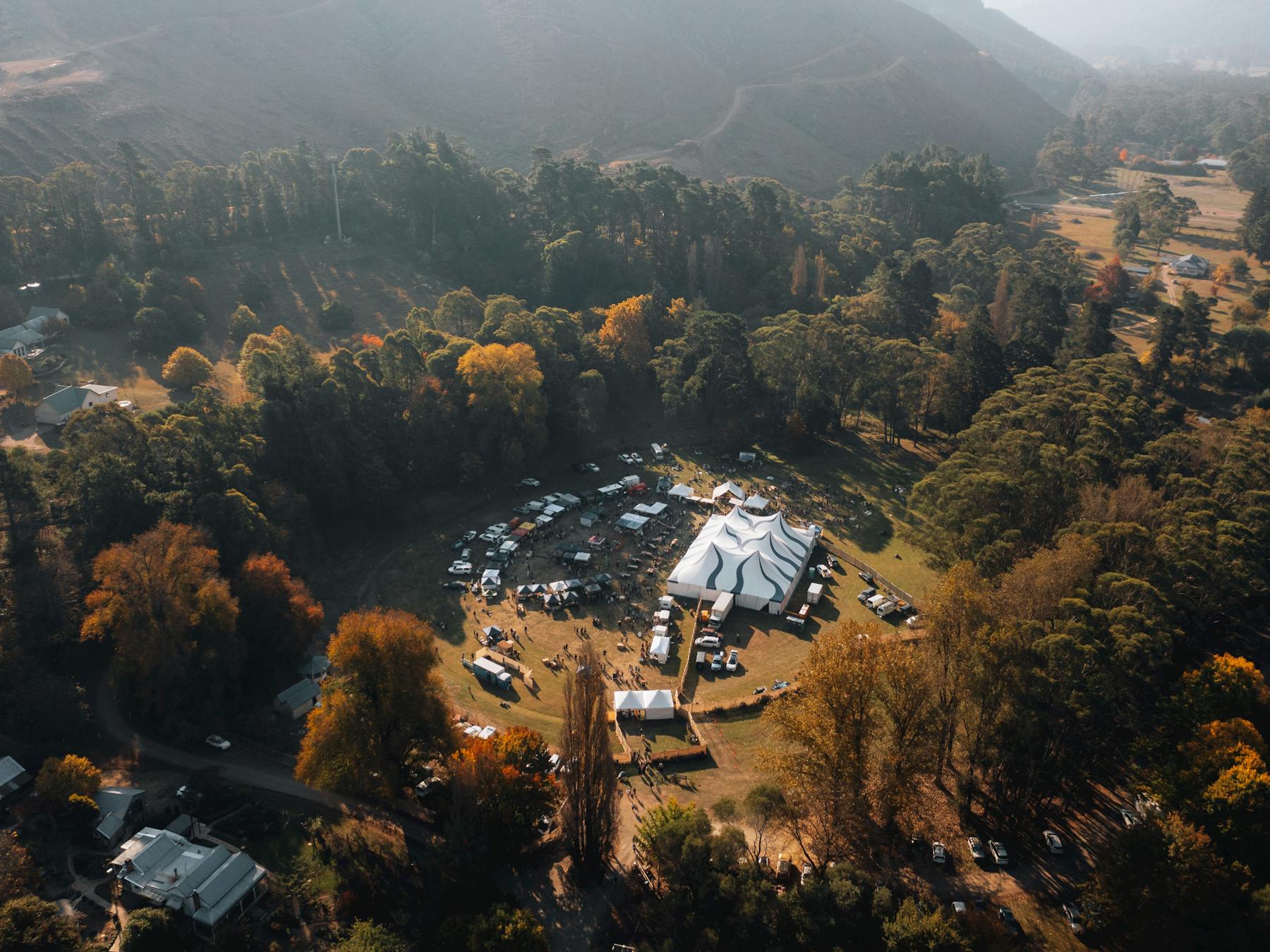 Birds eye view of the 2024 festival with big top tent and stalls surrounded by autumn colours