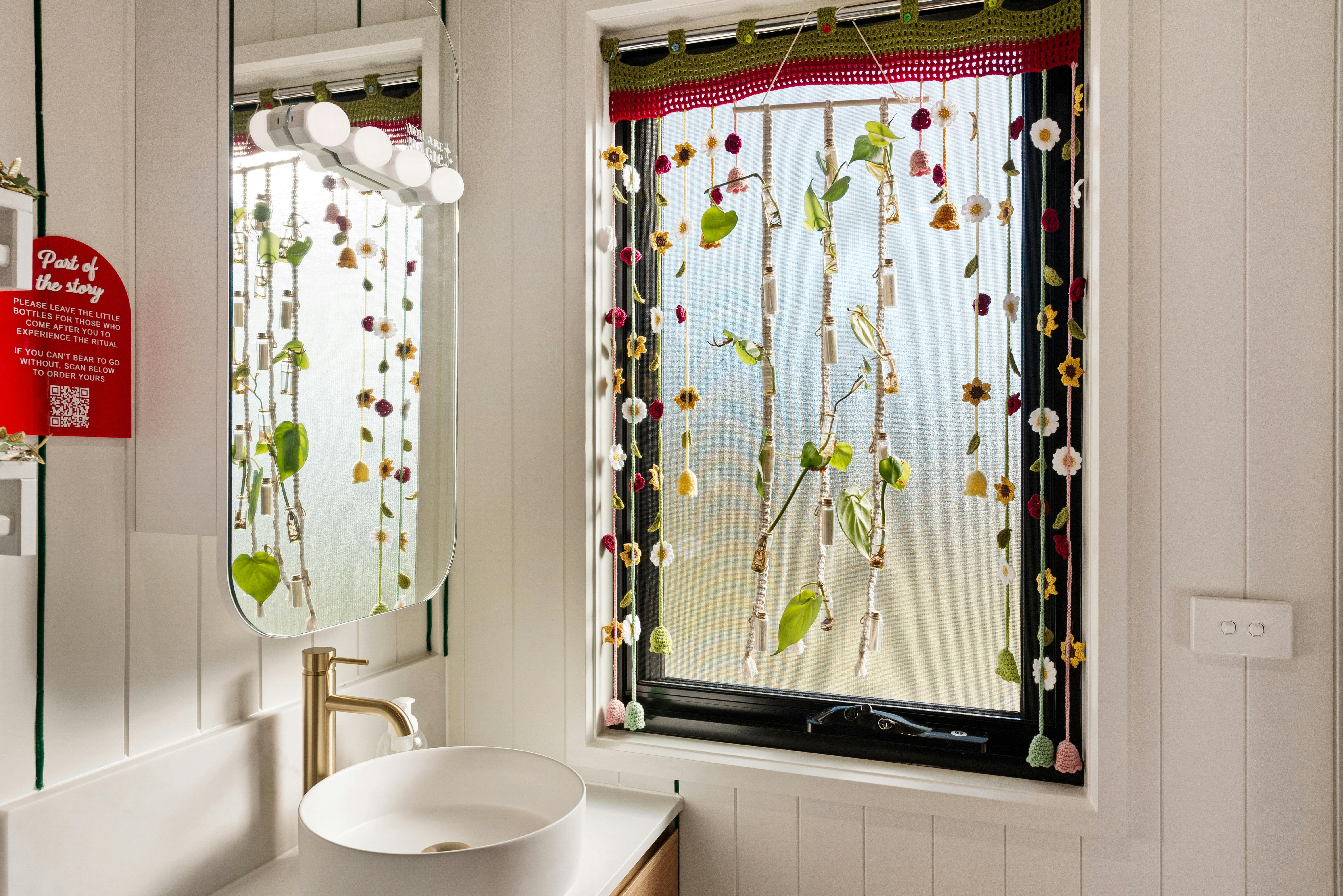 Interior of the bathroom window showing poetry and plants