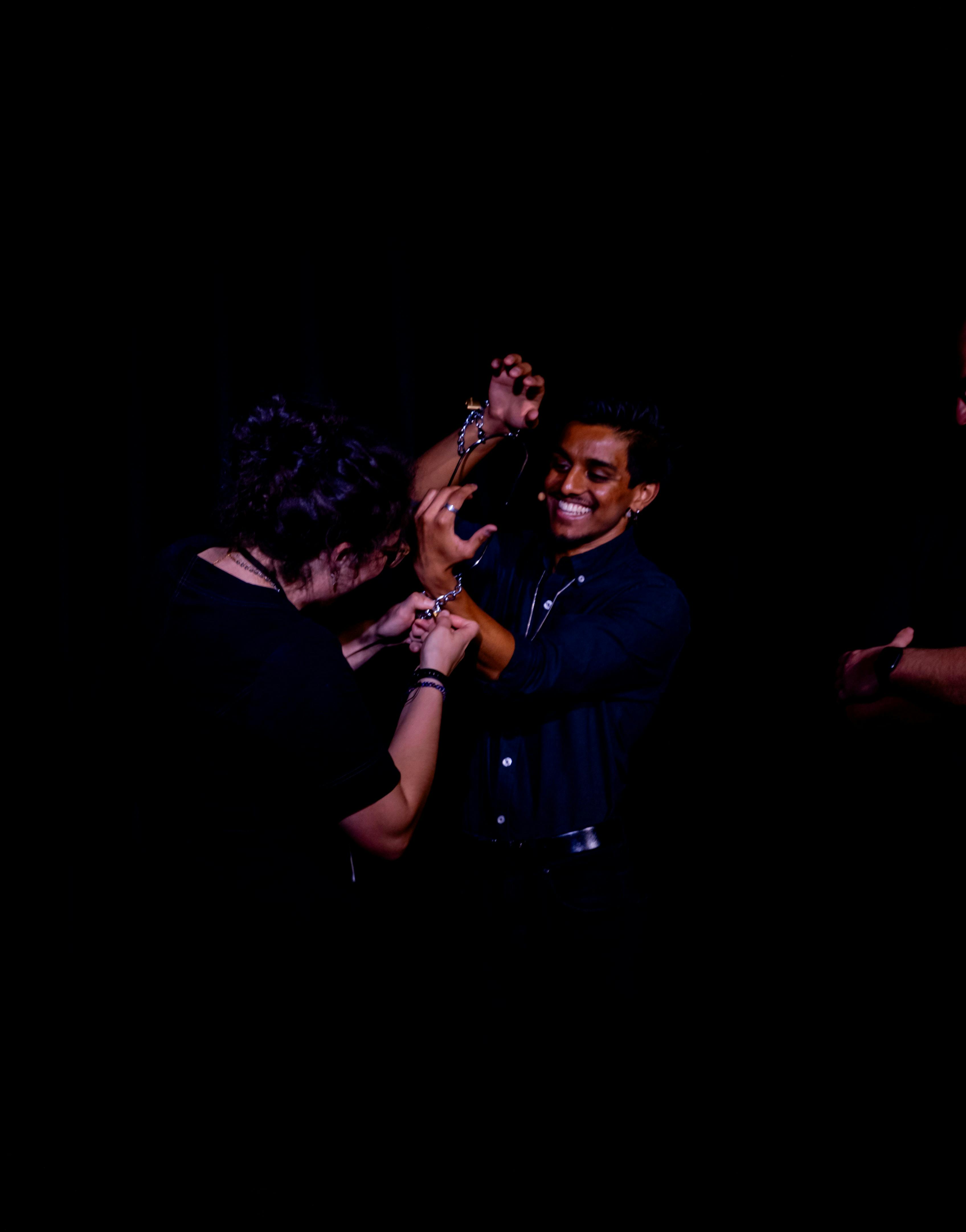Aadi being chained in handcuffs