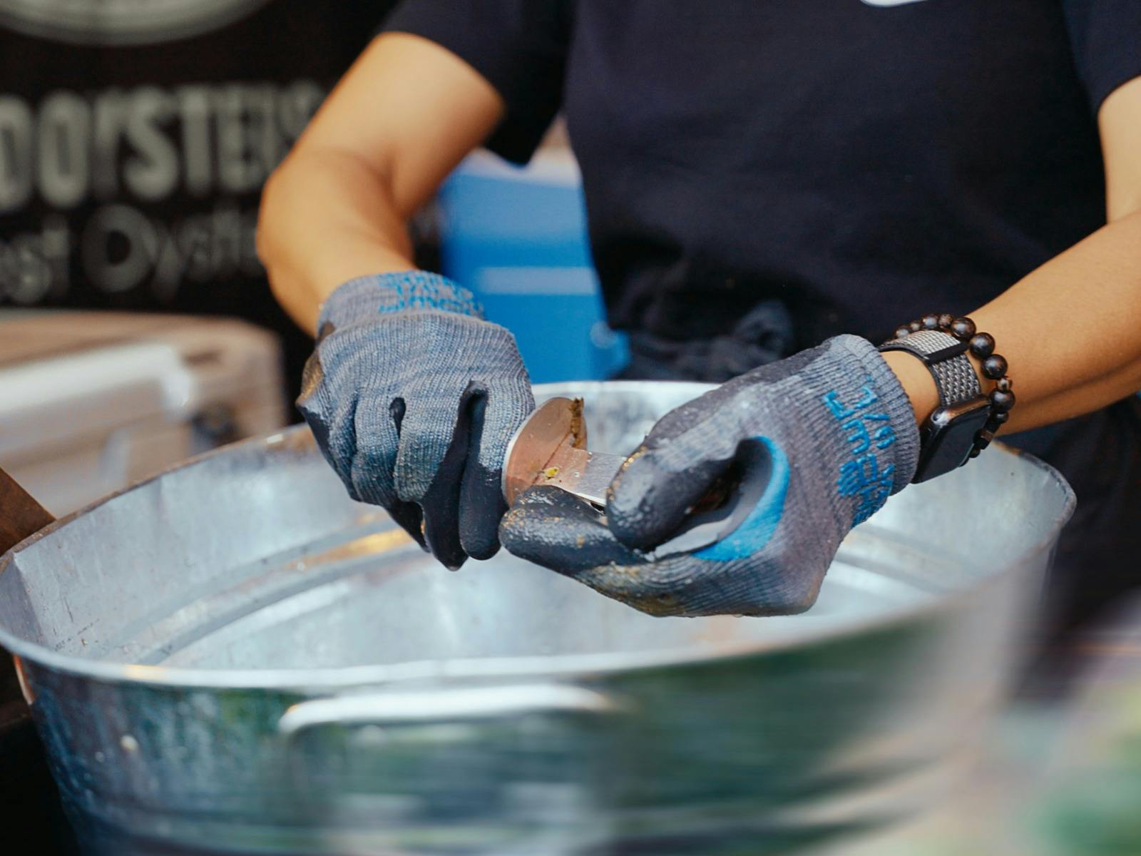 Image of an Oyster being schuked at the Tasmanian Wine Festival