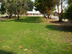 Camping sites are on grass bordered by trees.  A short walk to the amenities block & camp kitchen